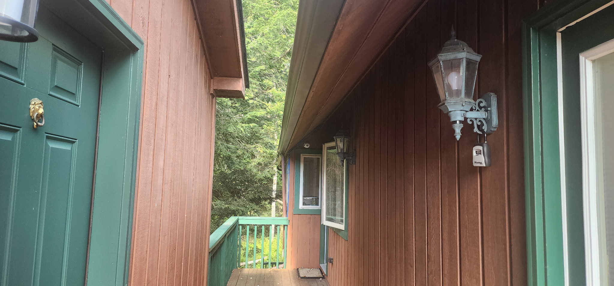 Cozy cabin-style entry with forest views and private deck walkway