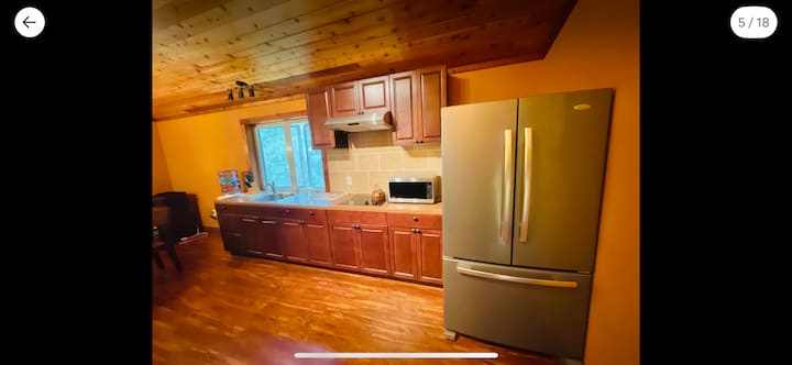 Cozy rustic kitchen with wood finishes and a large stainless fridge