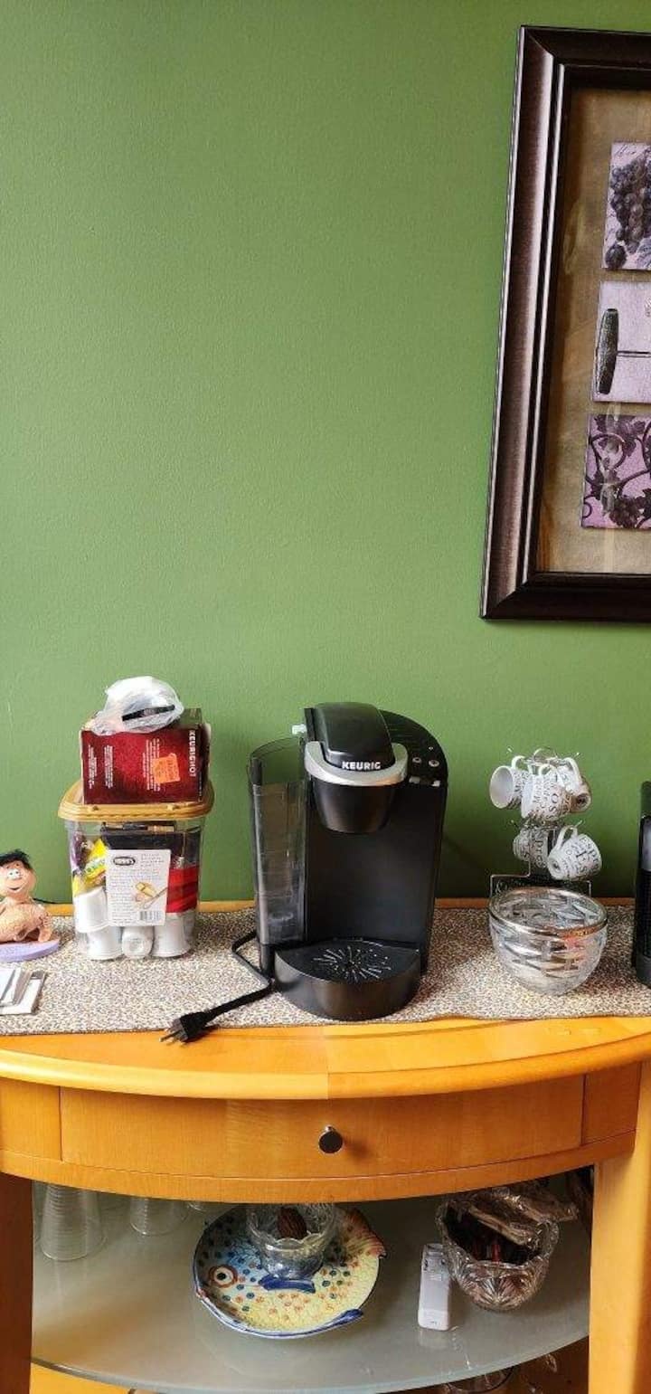 Inviting coffee station with Keurig, mugs, and stylish accent wall
