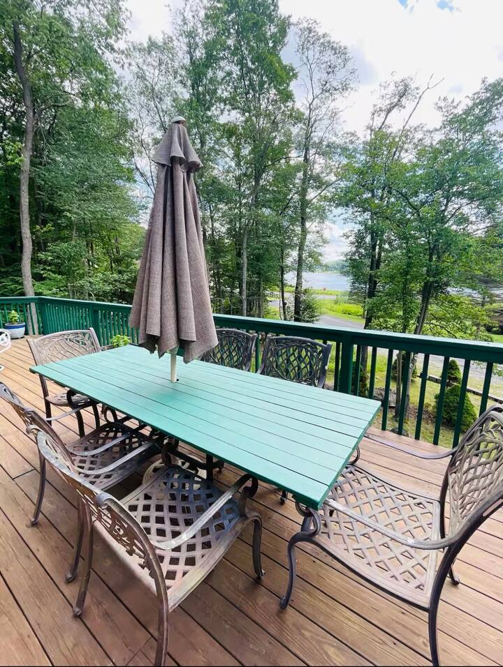 Private wooded deck with outdoor dining and peaceful water views