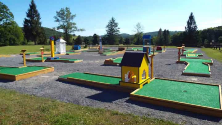 Colorful outdoor mini golf course with scenic mountain views