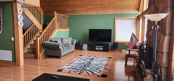 Spacious rustic living room with vaulted wood ceilings and cozy cabin charm