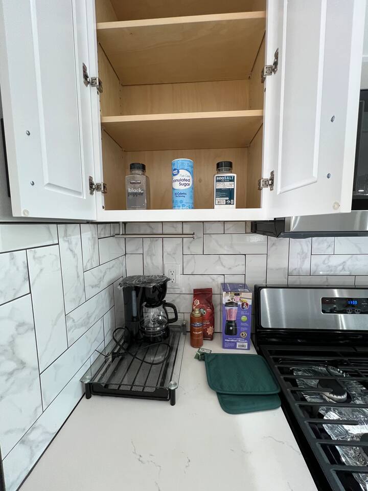 High-quality kitchen cabinetry featuring smooth-gliding navy blue drawers with modern black hardware and organized utensil storage.