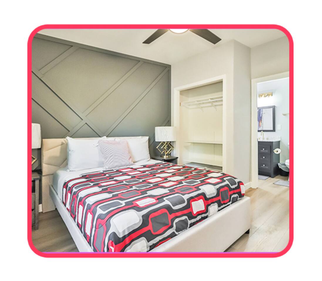 Modern bedroom with ensuite bath and open closet.