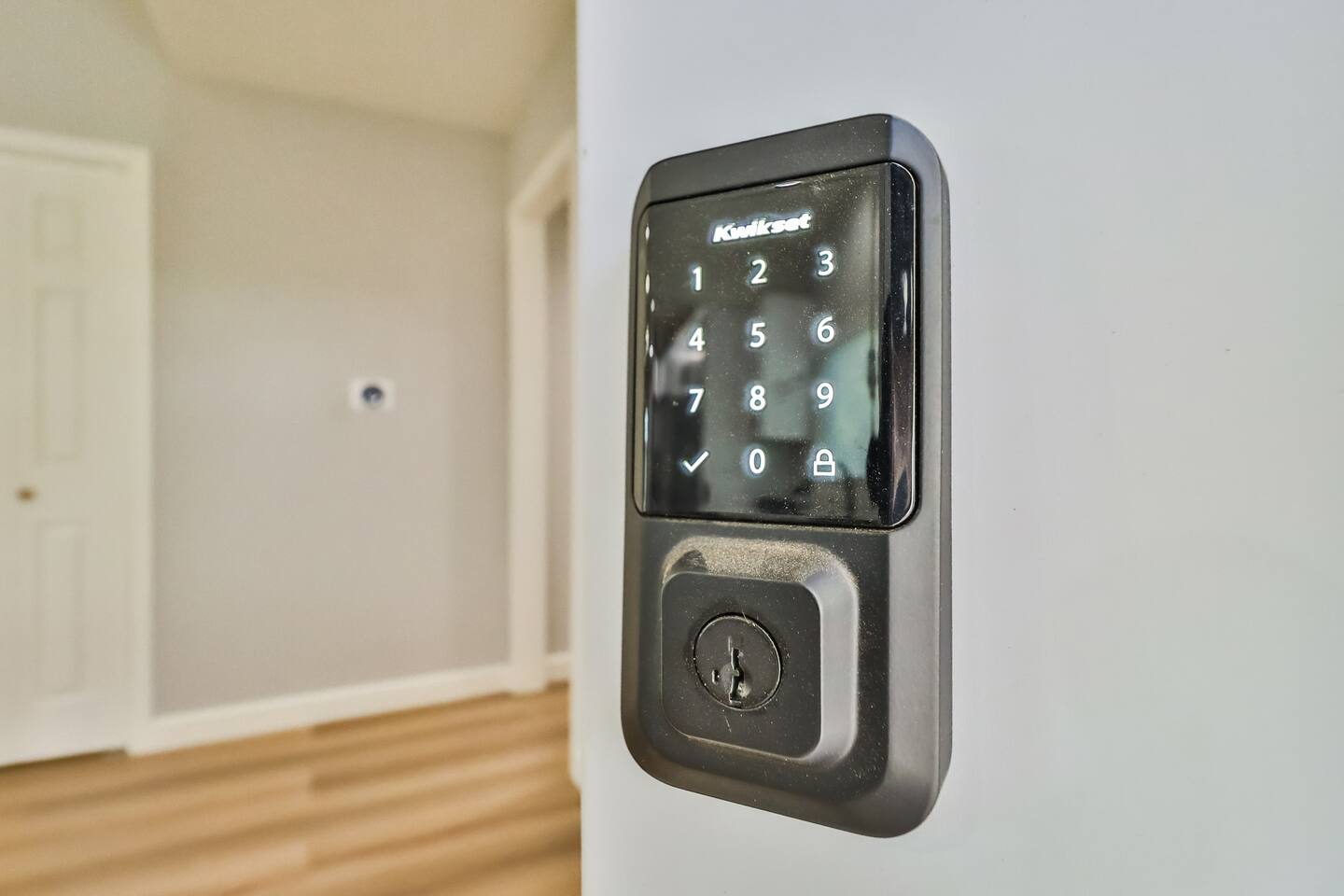 Modern keyless entry system featuring a sleek black Kwikset smart lock for secure and convenient access.