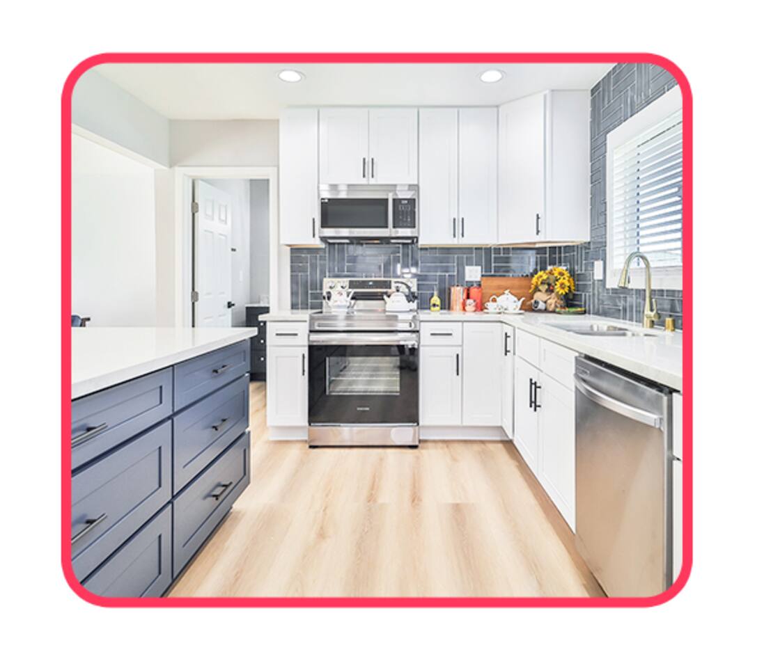 Modern Kitchen with White Cabinets, Blue Island & Sunlit Window – A Bright Space to Cook & Connect