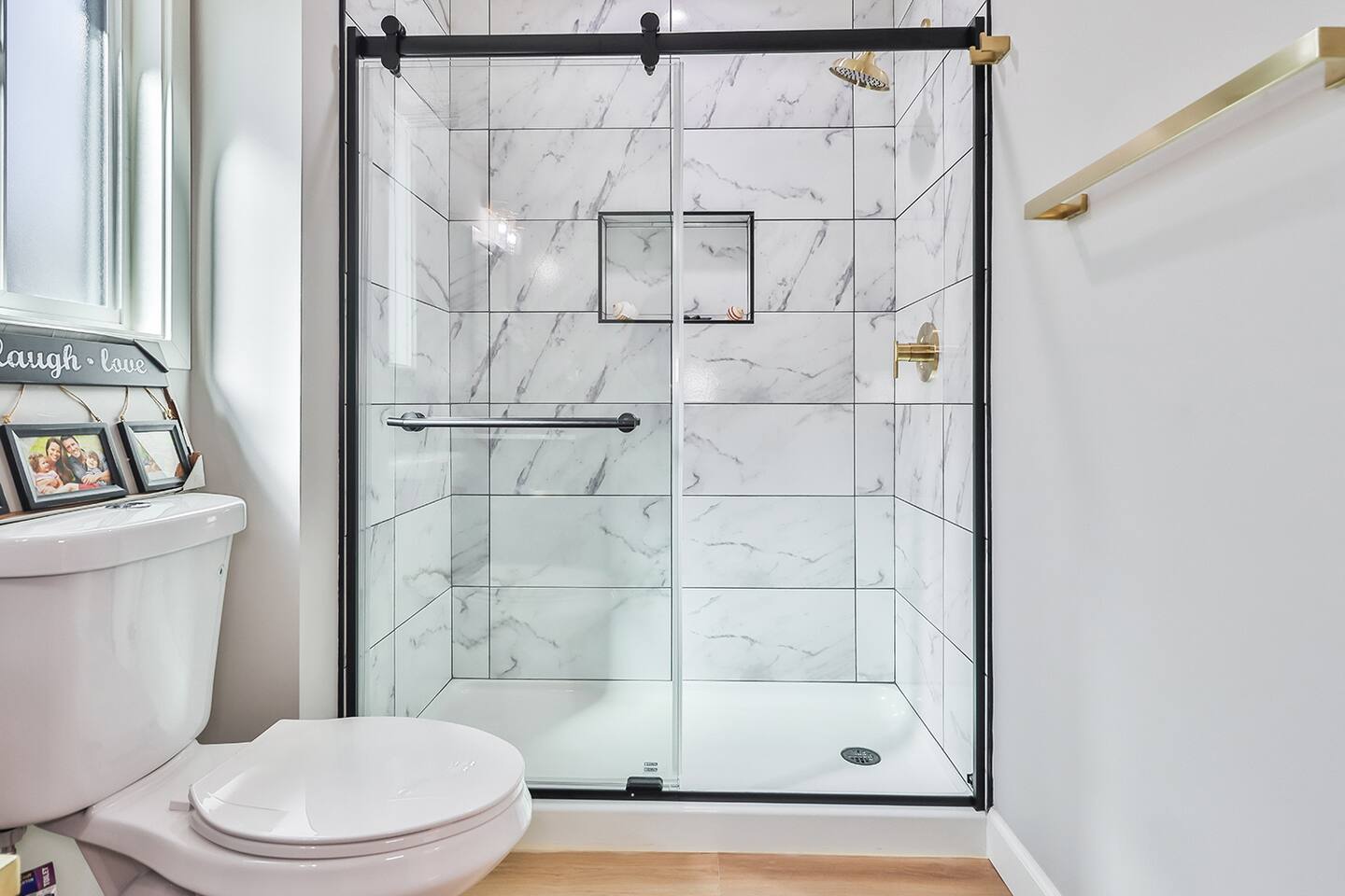 WALK-IN SHOWER WITH GLASS DOORS, MODERN VANITY WITH GOLD FAUCET