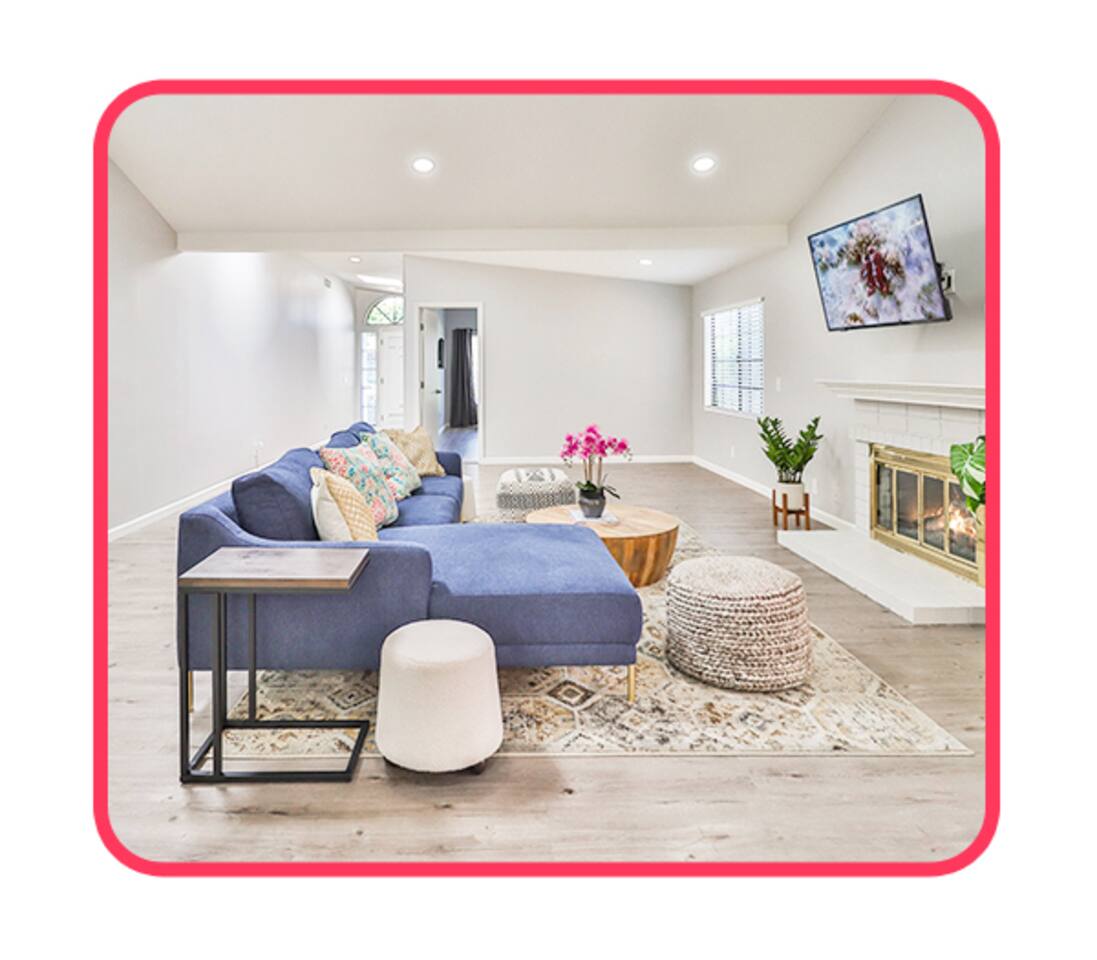 Stylish living room with fireplace and orchid centerpiece