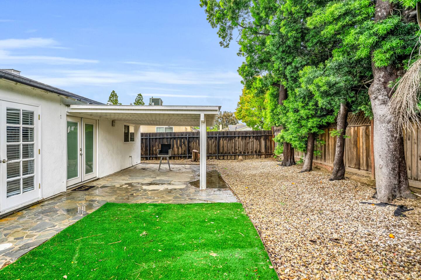 Private backyard with patio and seating.