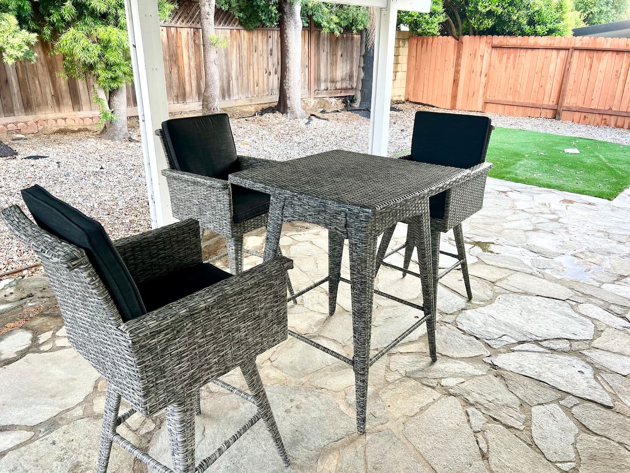 Shaded patio with dining and workspace setup.