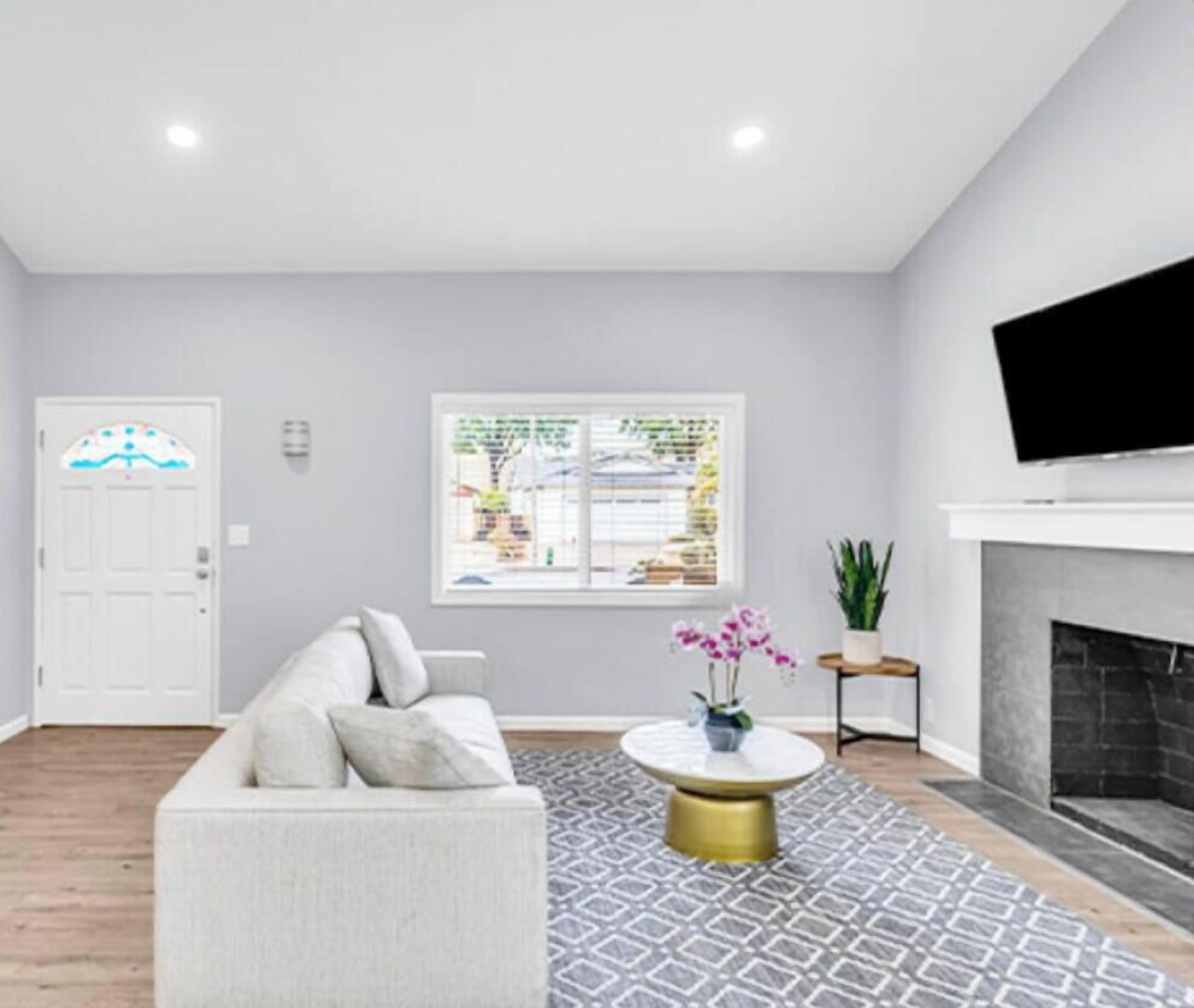 Elegant living room with fireplace and smart TV.