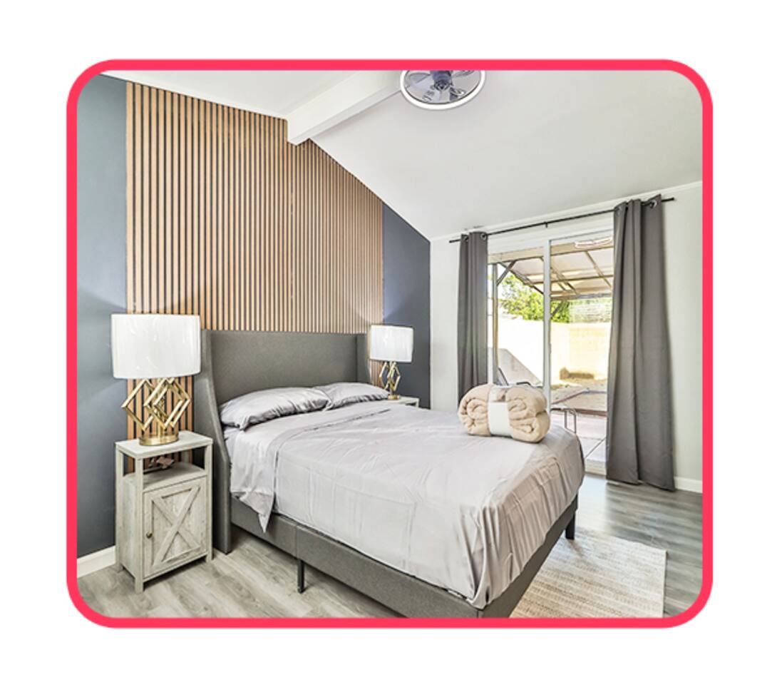 ersatile bedroom layouts featuring a built-in floating desk, comfortable bedding, large windows, and a stylish dark geometric accent wall.