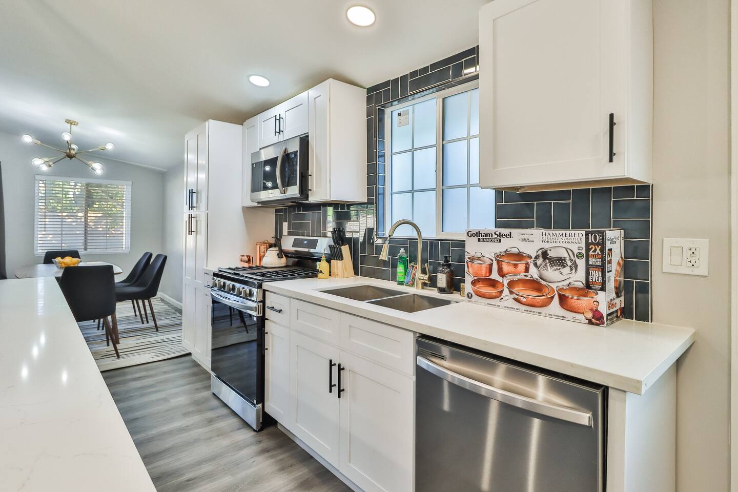 MODERN KITCHEN WITH GAS RANGE, STAINLESS STEEL APPLIANCES