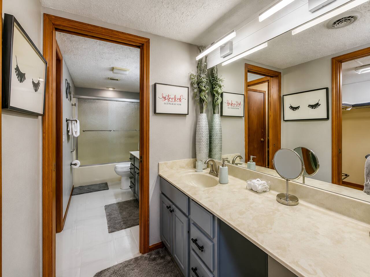 Plenty of space for the family to get ready! This bright bathroom features a large vanity, oversized mirror, and full tub/shower—making busy mornings and bedtime routines easier before or after a fun day exploring Gatlinburg.