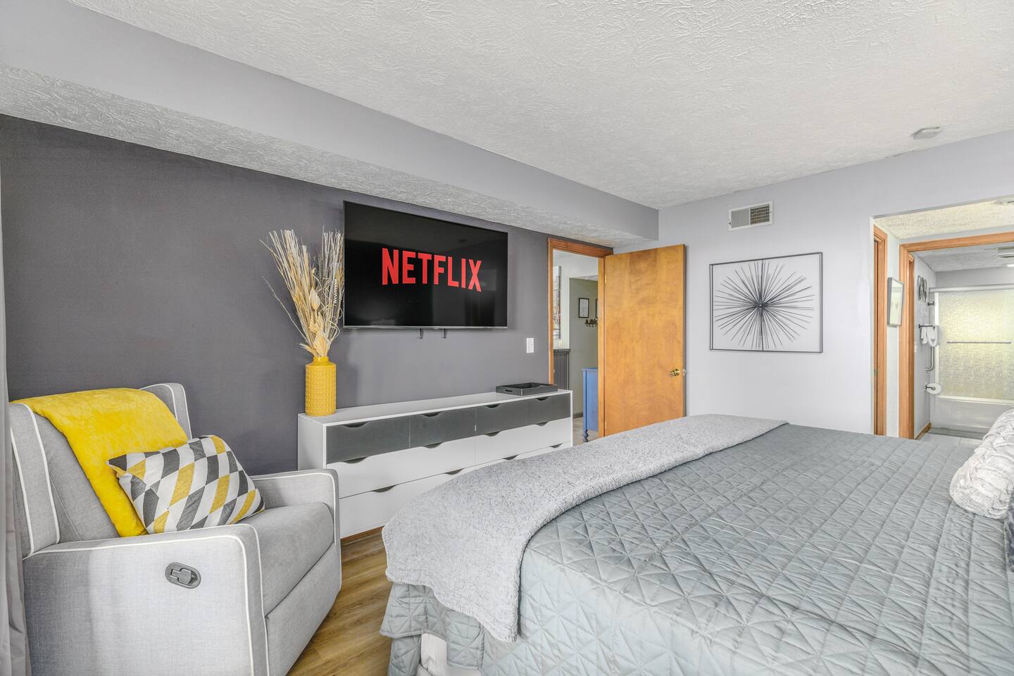 Unwind in this spacious king bedroom with a Smart TV, cozy recliner, and private bathroom nearby. Parents can relax with their favorite show after a fun-filled day exploring Gatlinburg and the Smoky Mountains.