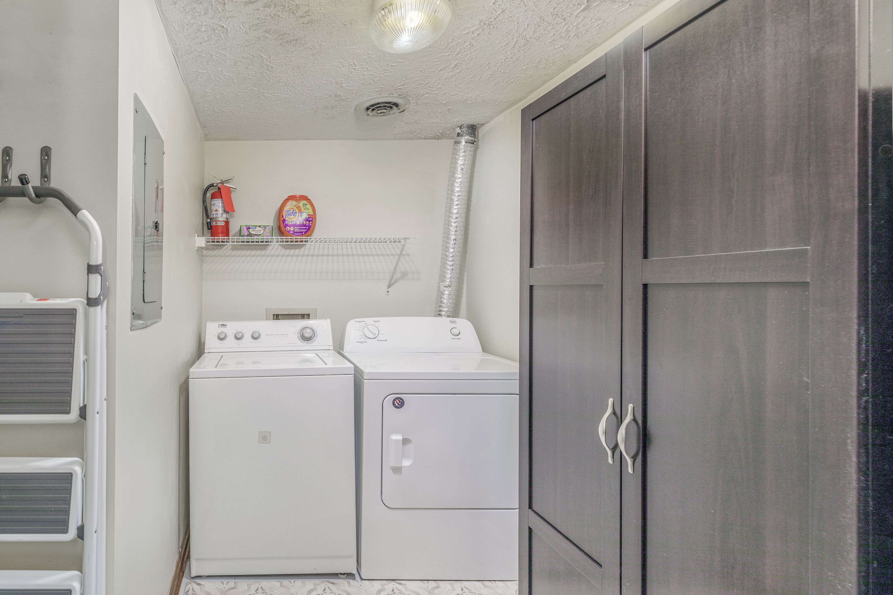 Private laundry room with washer, dryer and extra storage for longer stays.