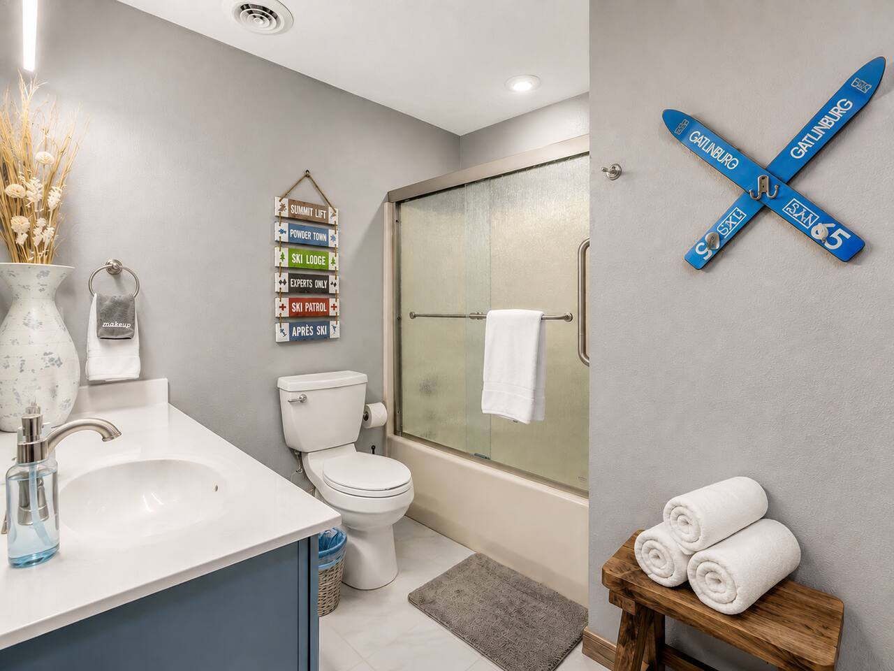 A convenient full bathroom for the family featuring a spacious vanity and tub/shower combo. Fun ski-themed touches carry the mountain vibe throughout, while the bathtub makes cleanup easy after a day of Smoky Mountain adventures!