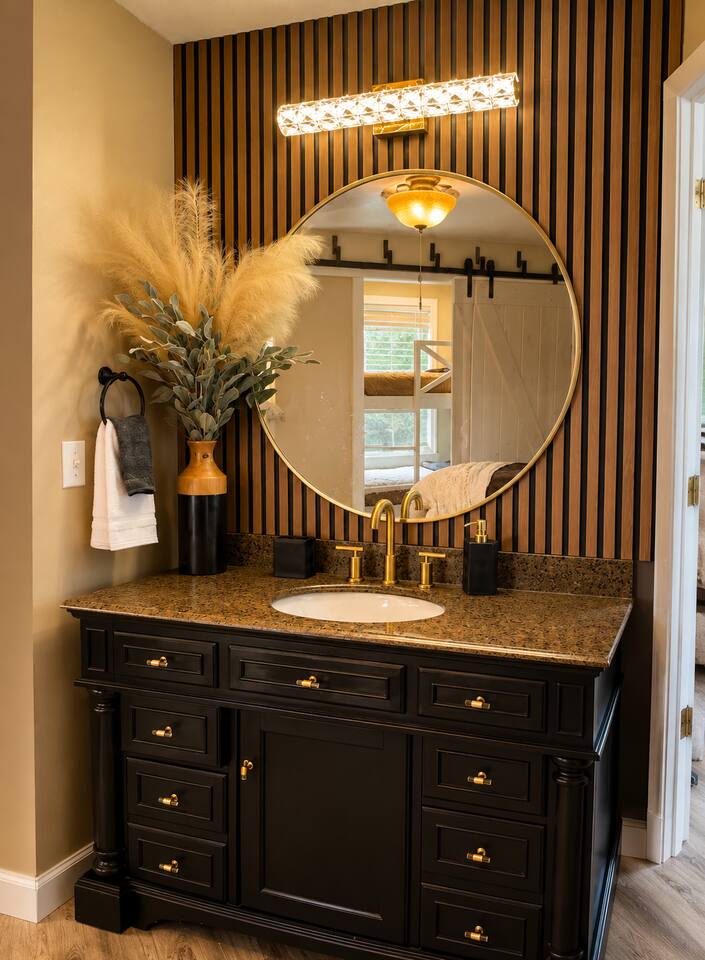 A stylish, thoughtfully designed vanity offers the perfect space to get ready for the day or a night out in Gatlinburg. Enjoy flattering lighting, a spacious countertop, elegant gold accents, and plenty of room for your beauty essentials.