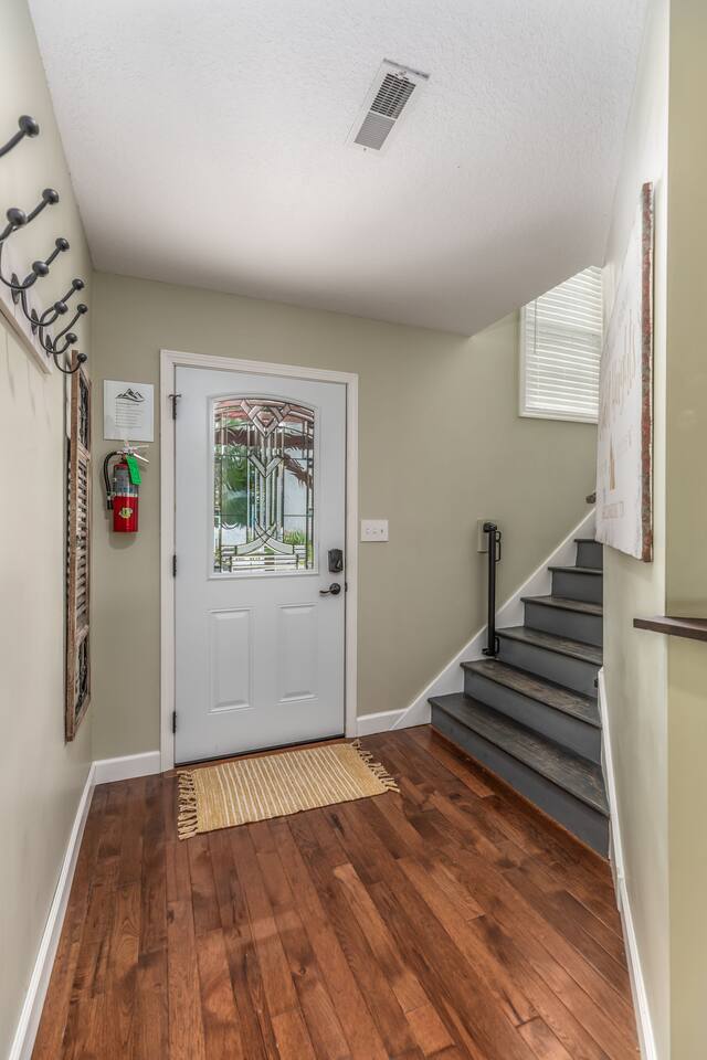 Entry way with a child safety gate for staircase.