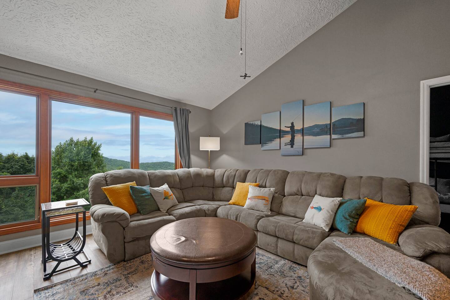 Stretch out and relax with the whole family in this spacious living room! The oversized sectional offers plenty of room for everyone, while wall-to-wall windows showcase beautiful Smoky Mountain views—the perfect family gathering spot.