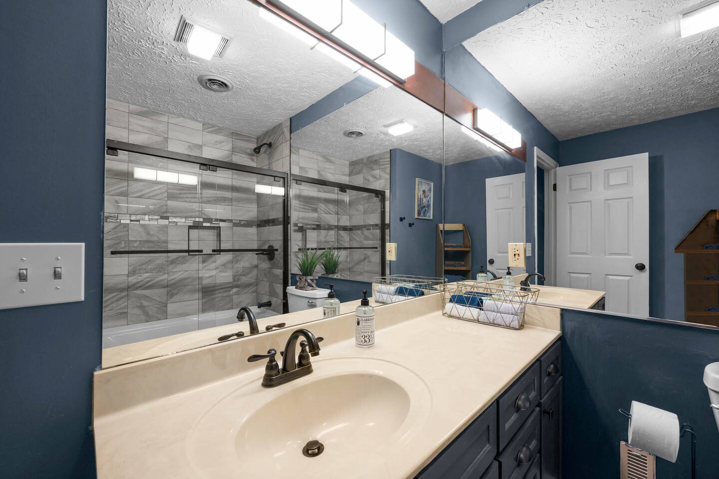 Attached bathroom to bunk room including a shower and standard bathroom tub