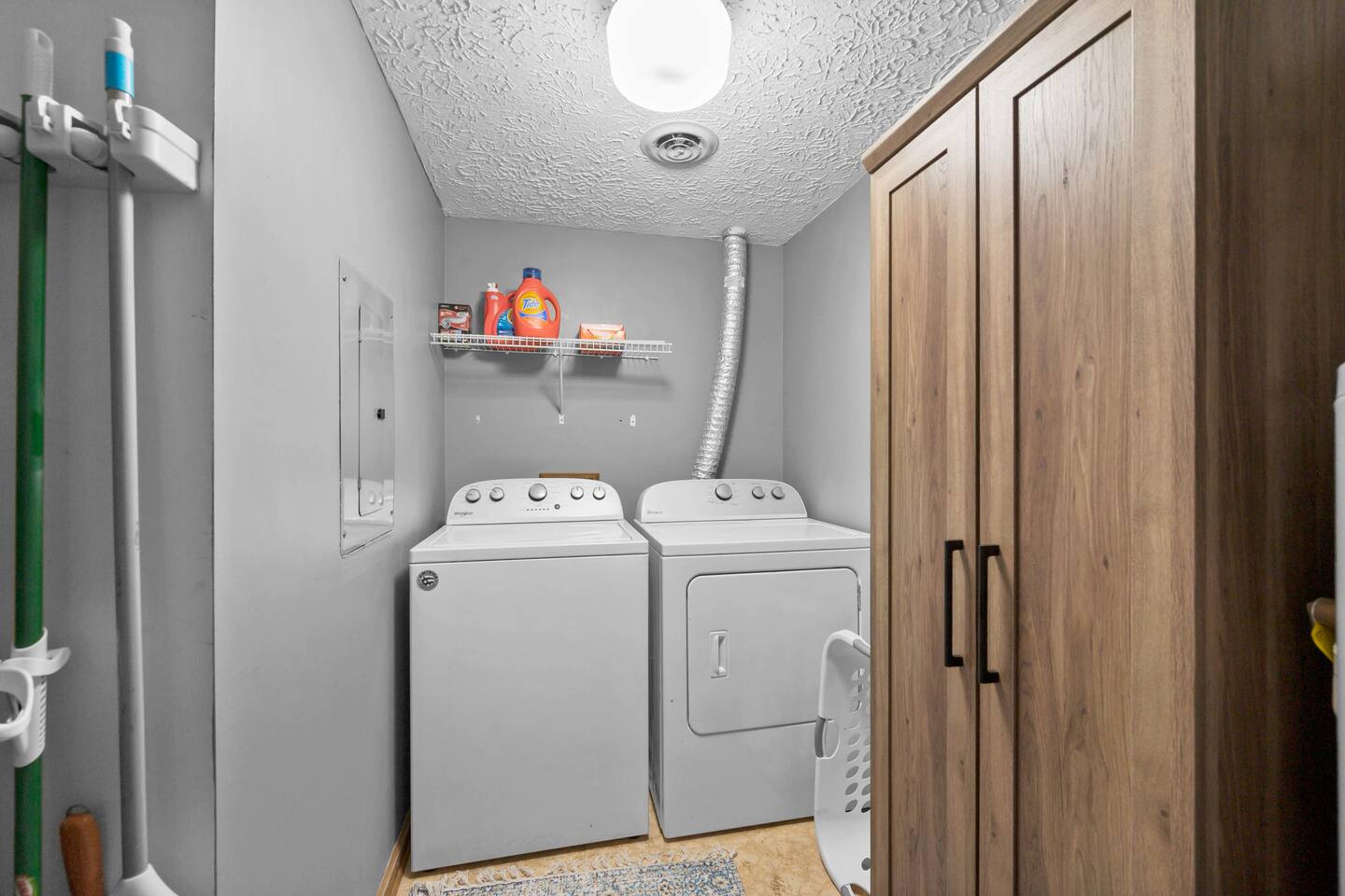 Laundry room with full size washer and dryer with large pantry for storage