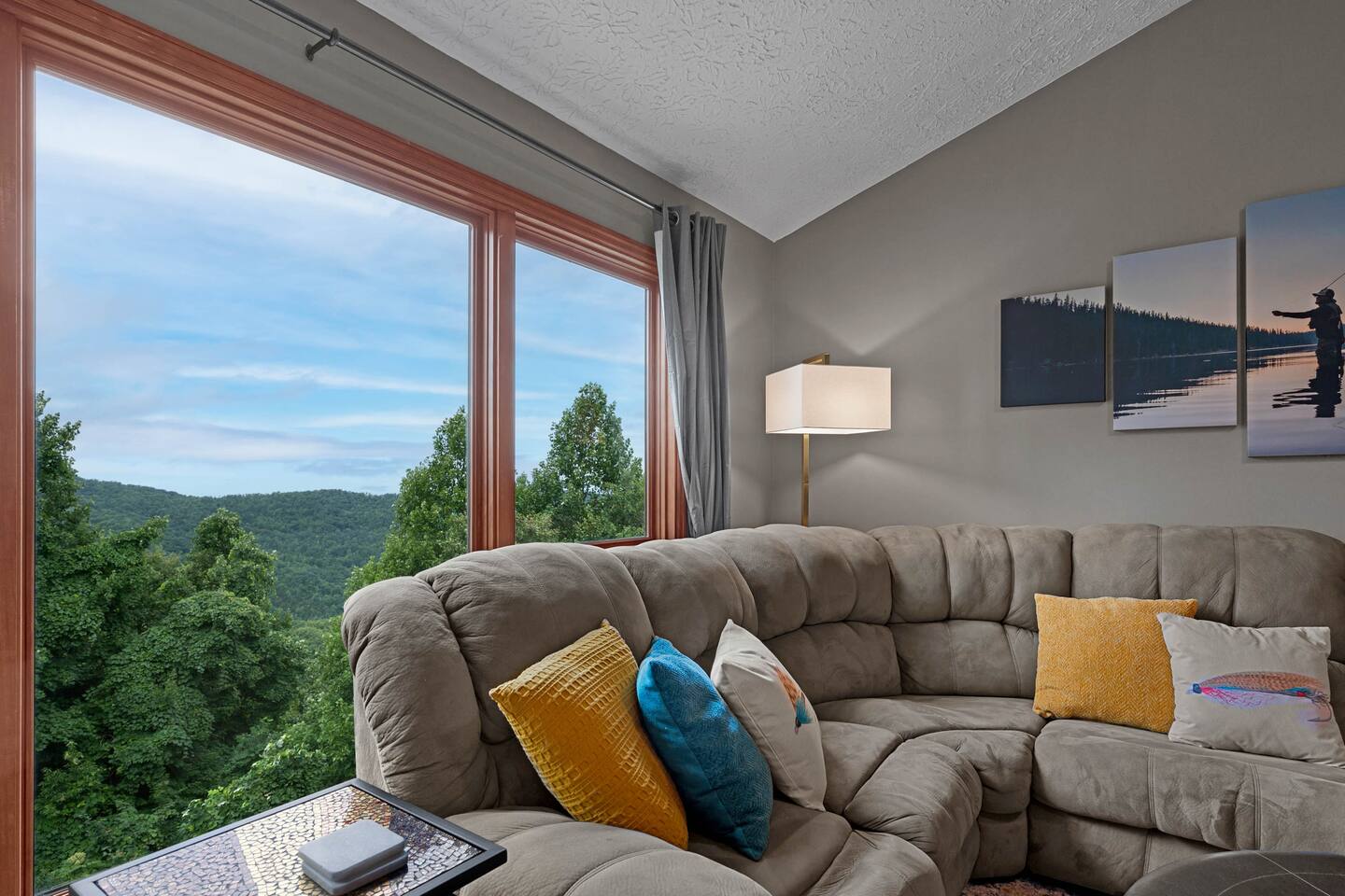Gather the family and unwind in this cozy living room, where oversized windows frame beautiful Smoky Mountain views. Plenty of comfortable seating makes it the perfect spot for movie nights, games, and relaxing together.