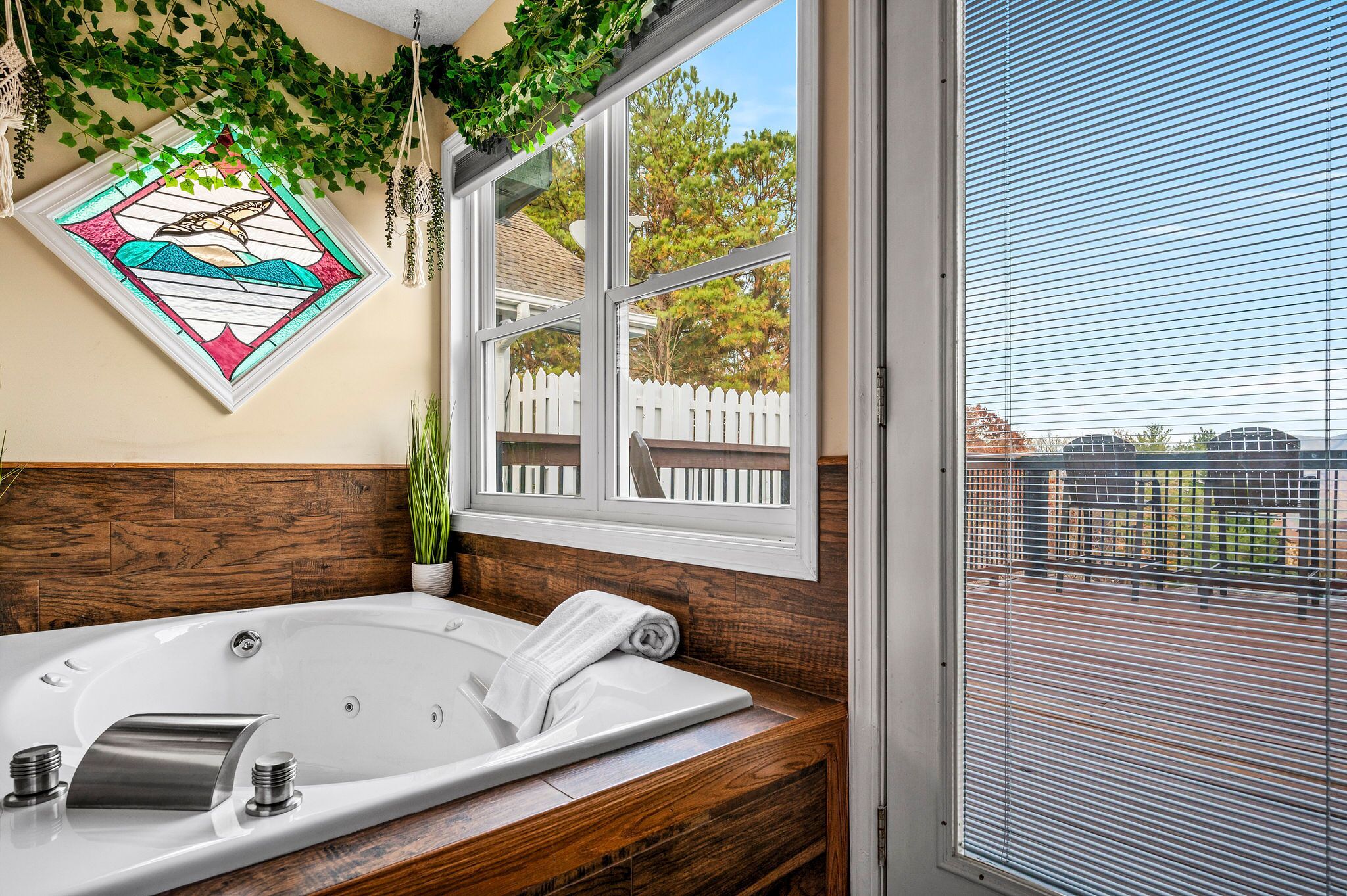 Unwind in the spacious jetted tub, surrounded by natural light and peaceful view