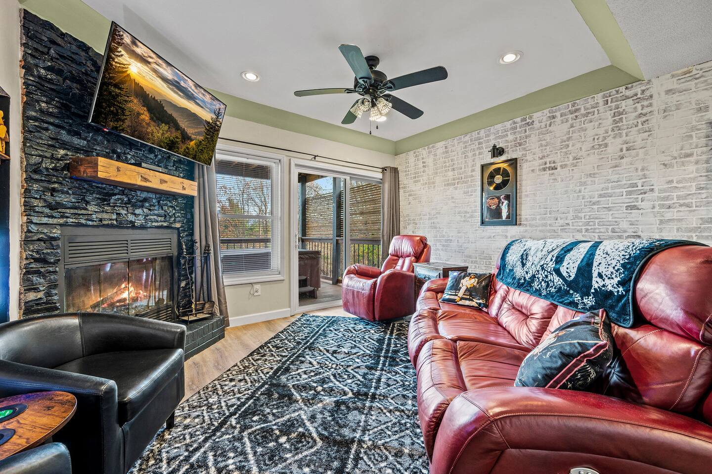 A cozy family gathering space with comfy seating, a warm fireplace, Smart TV, and easy deck access—perfect for movie nights and relaxing together after a day exploring the Smokies.