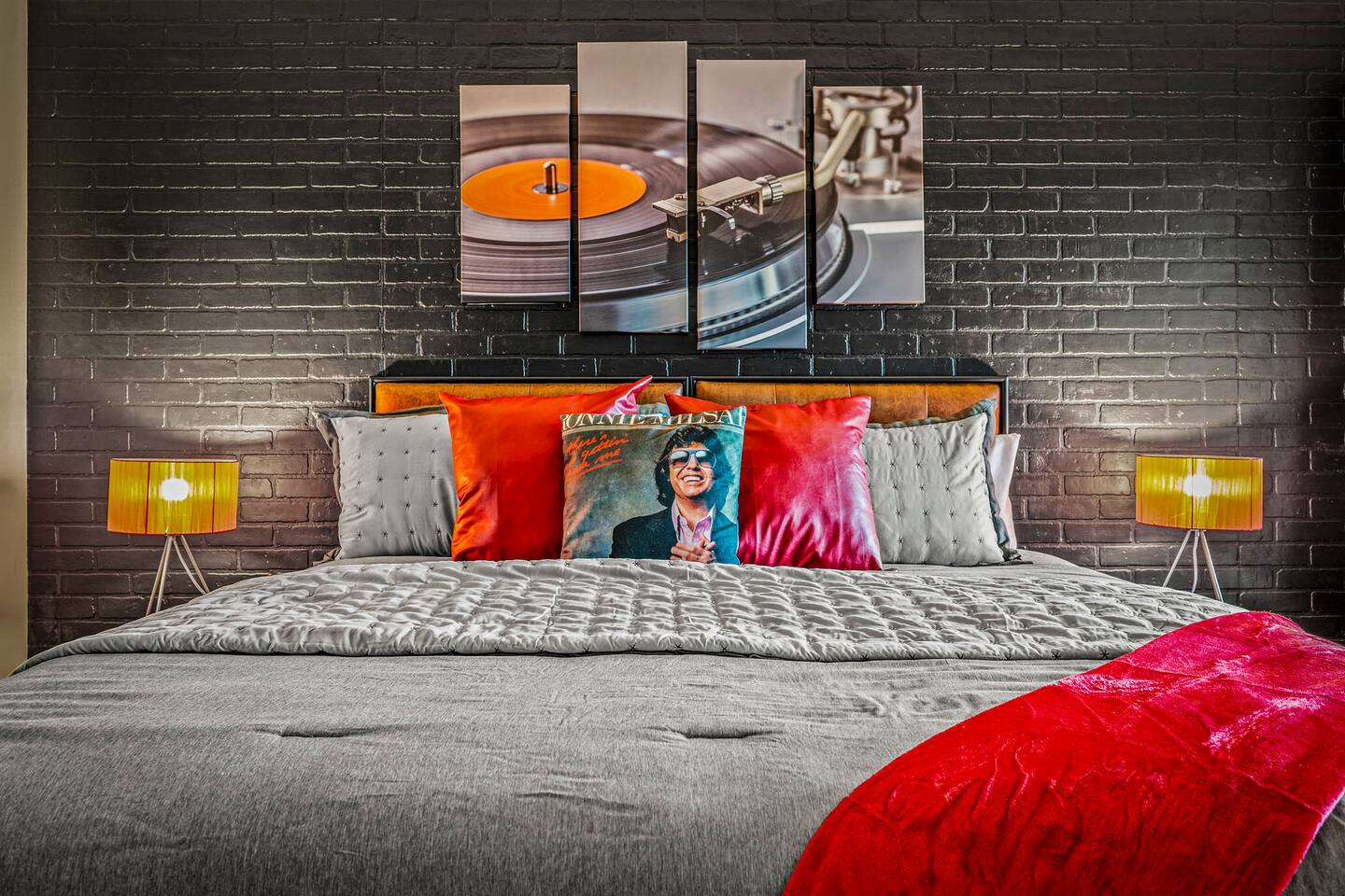 Relax in this stylish, music-inspired bedroom featuring cozy bedding and bold rock ’n’ roll décor. A fun and comfortable retreat for parents to unwind and recharge after a day of family adventures in the Smokies.