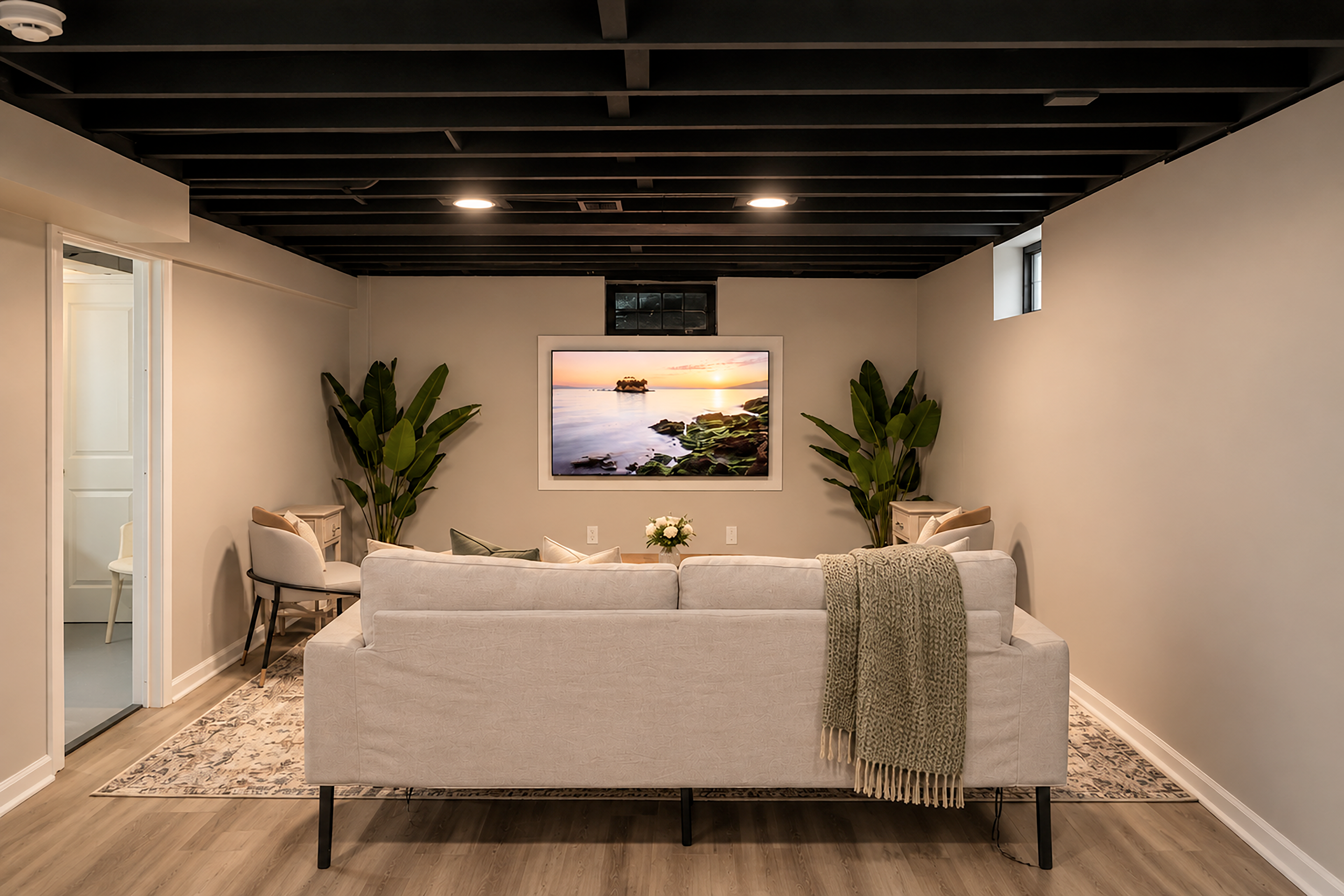 Cozy lower-level lounge with chic decor and spacious sofa seating