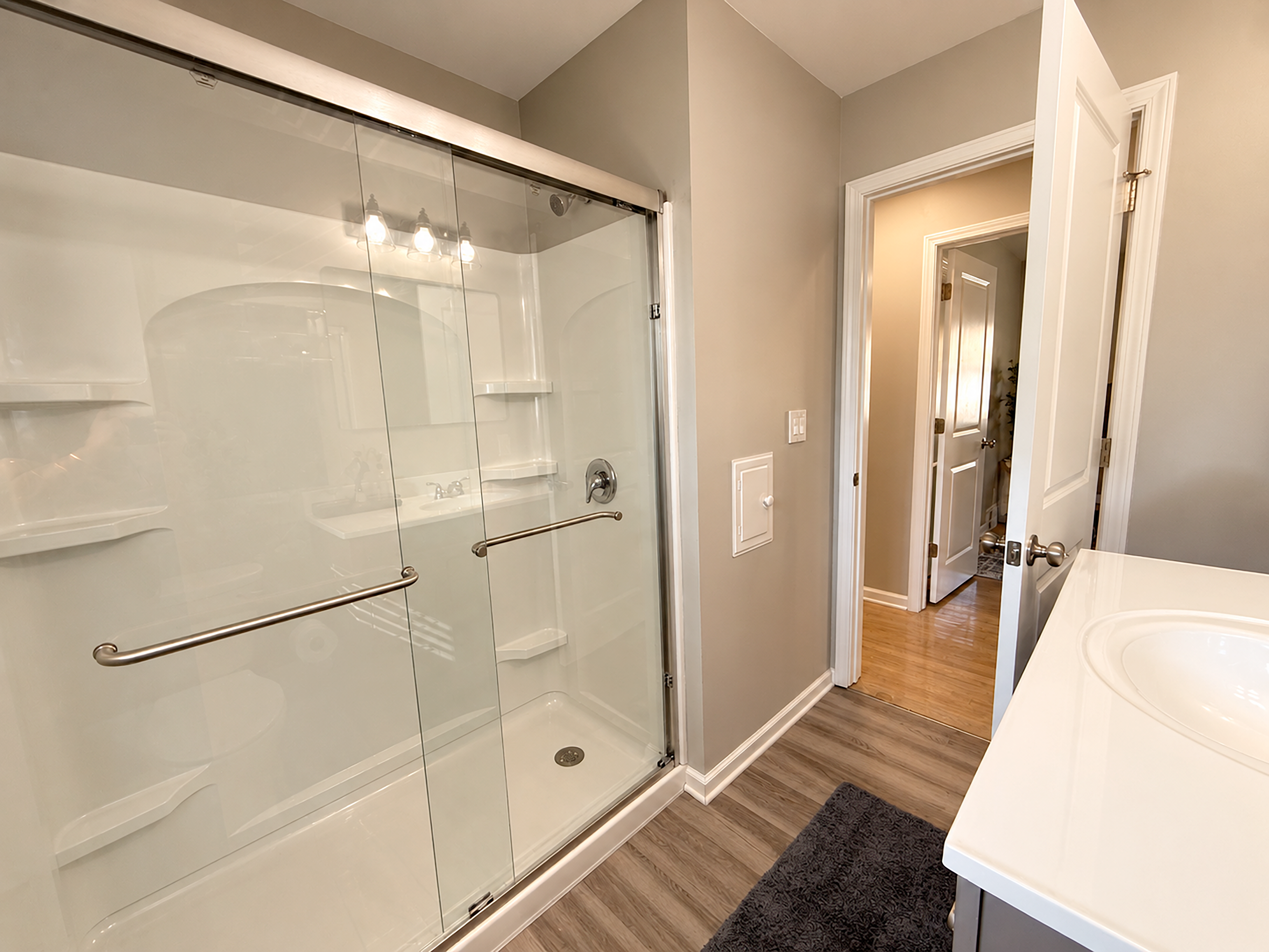 Bright modern bath with spacious glass walk-in shower