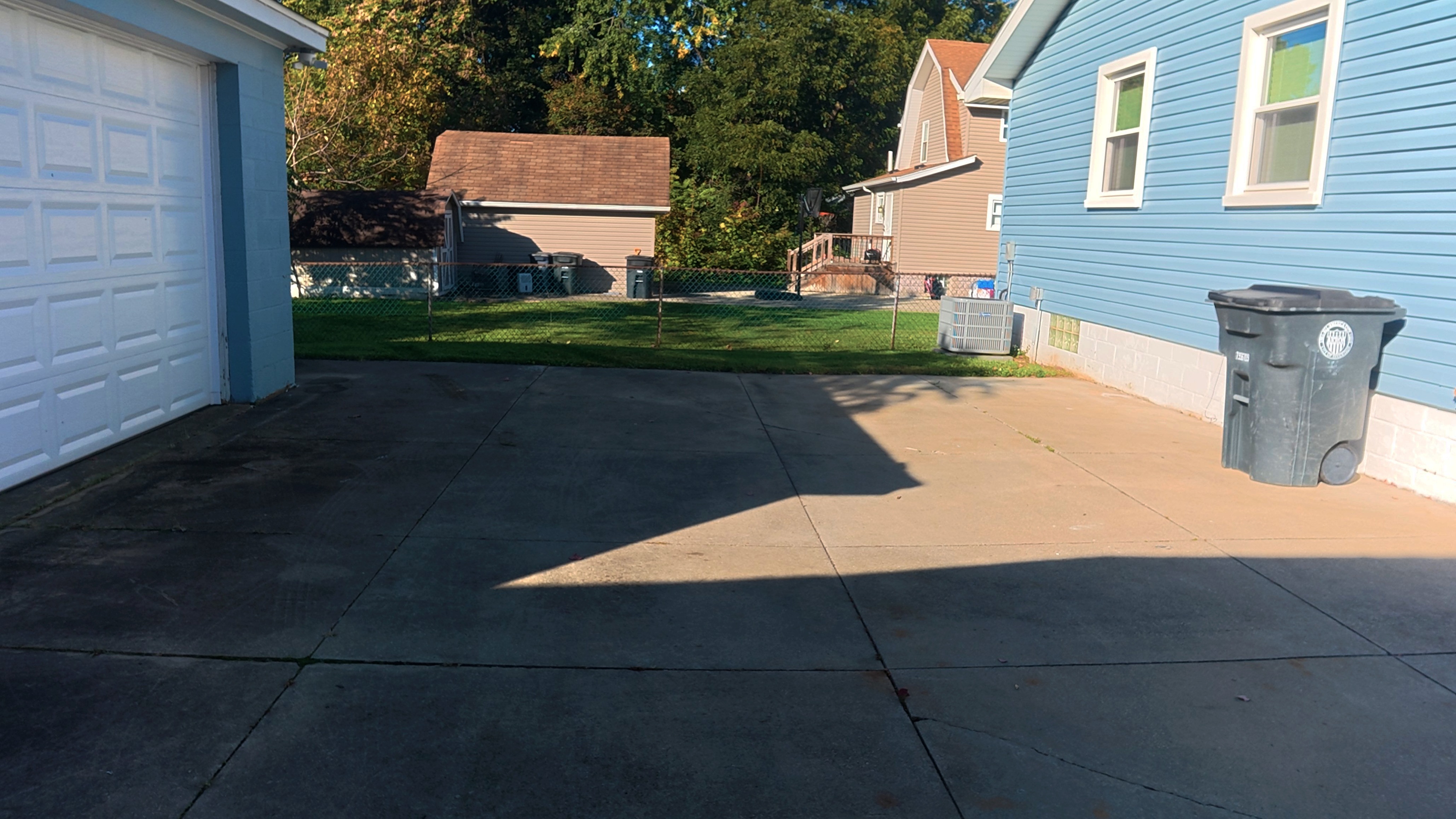 Spacious driveway parking with fenced backyard access