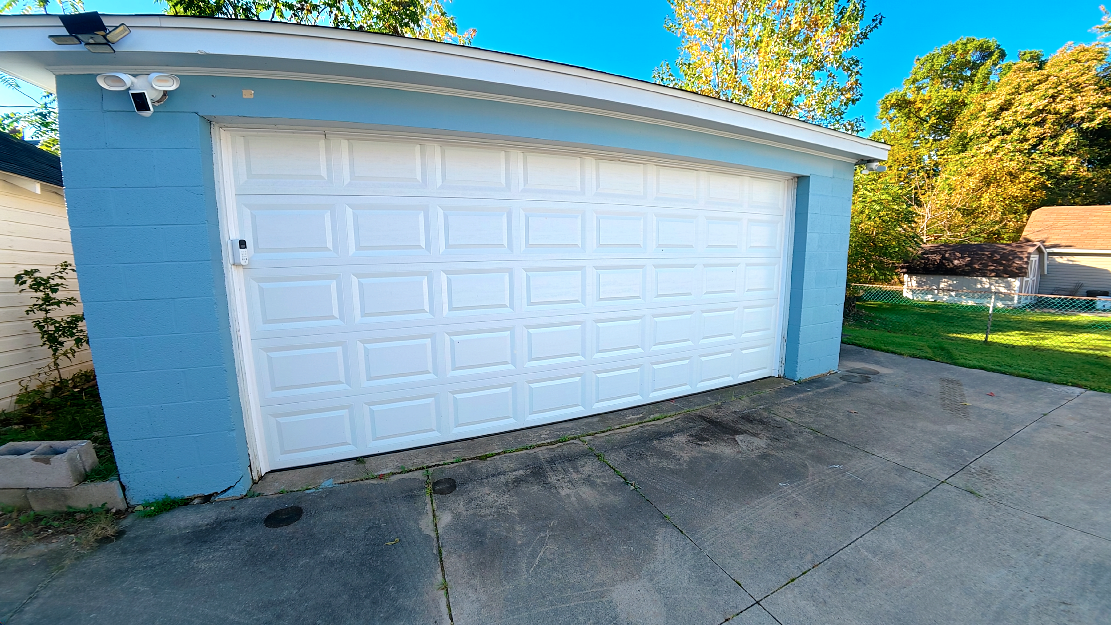 Spacious detached garage with wide driveway and convenient guest parking