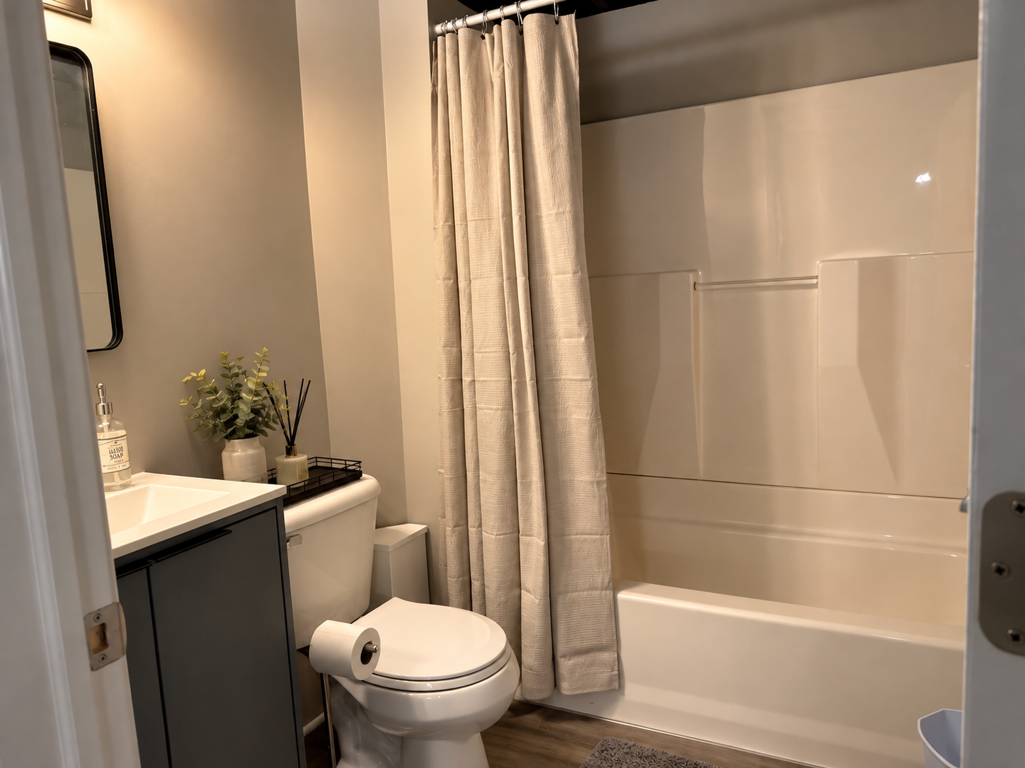 Bright modern bathroom with tub-shower combo and stylish finishes