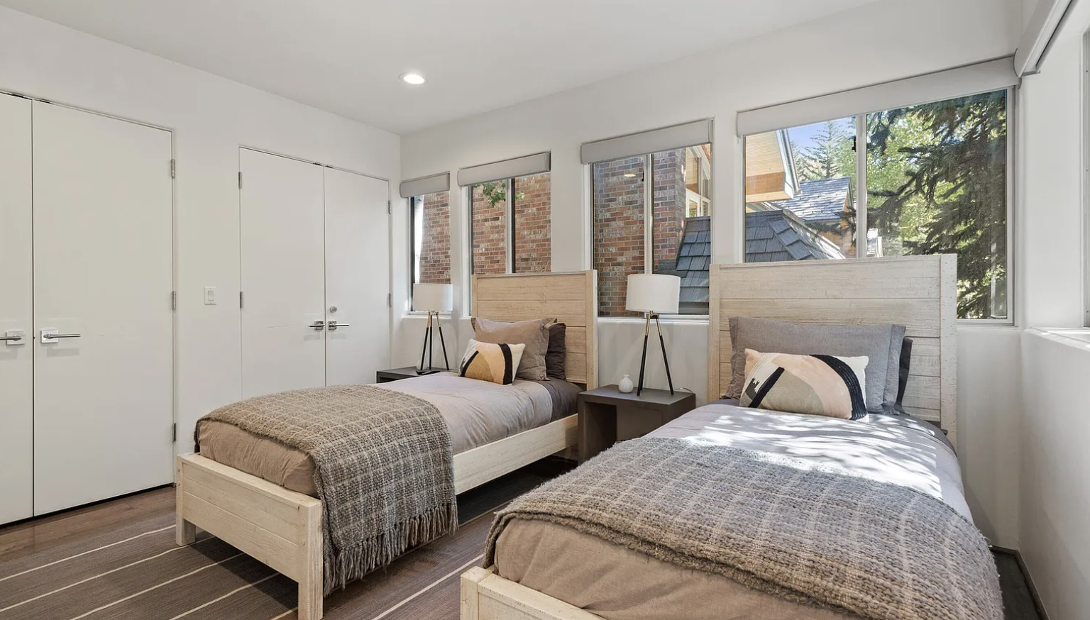 Bright twin bedroom with natural light and stylish modern finishes