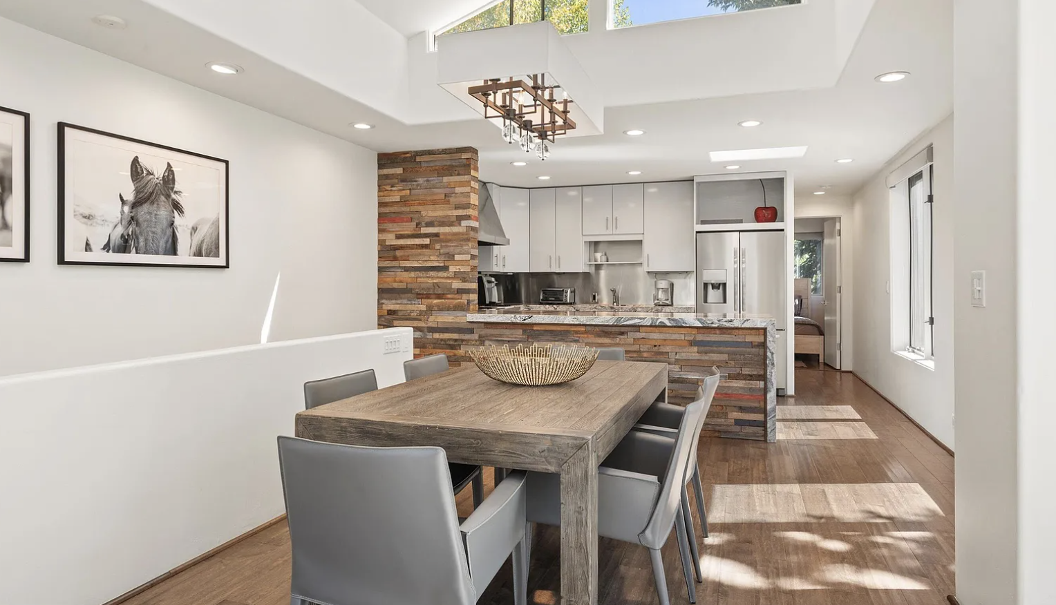 Bright open dining area with skylights and a stylish modern kitchen