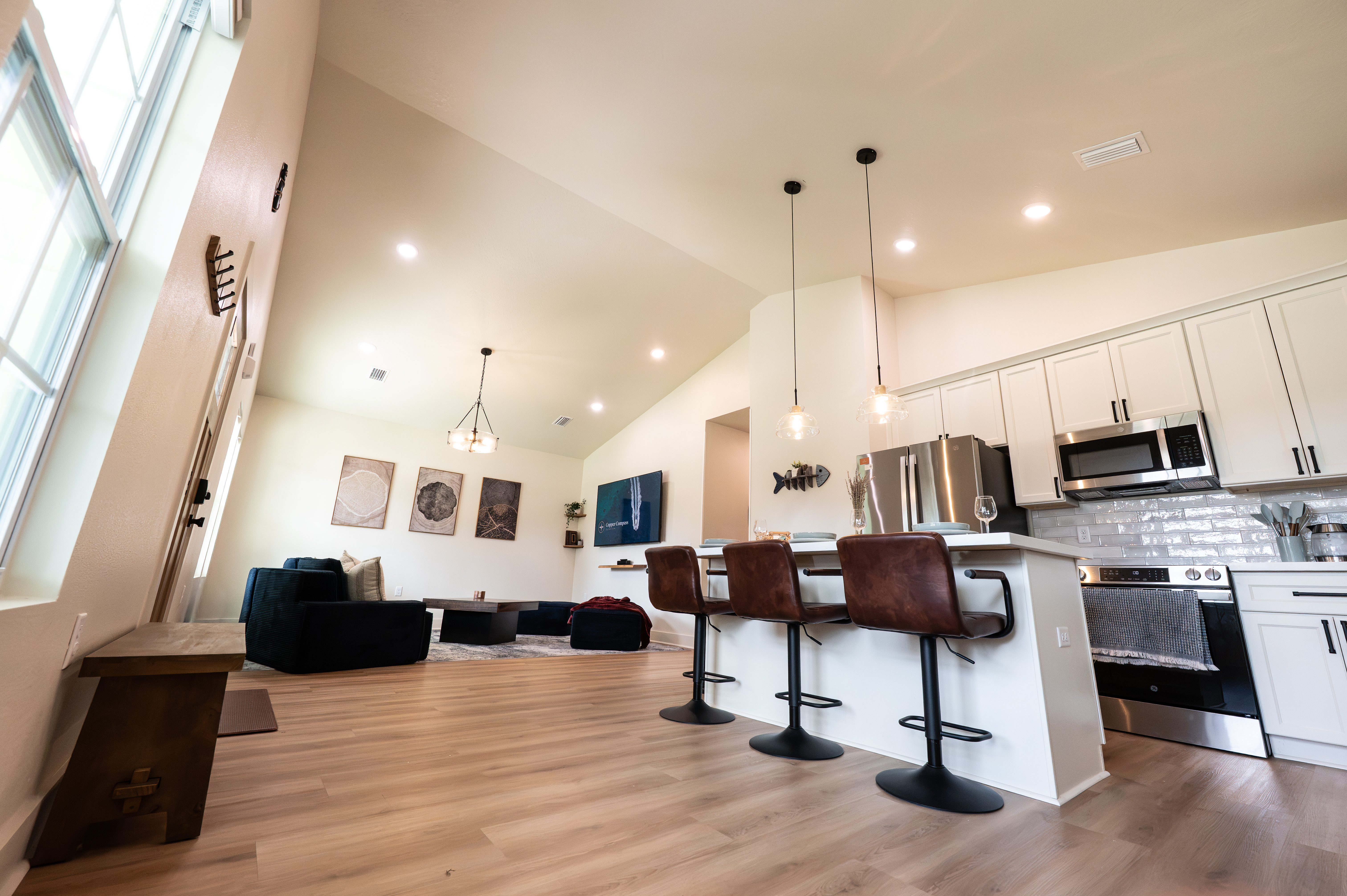 Bright open-concept kitchen and living area with vaulted ceilings