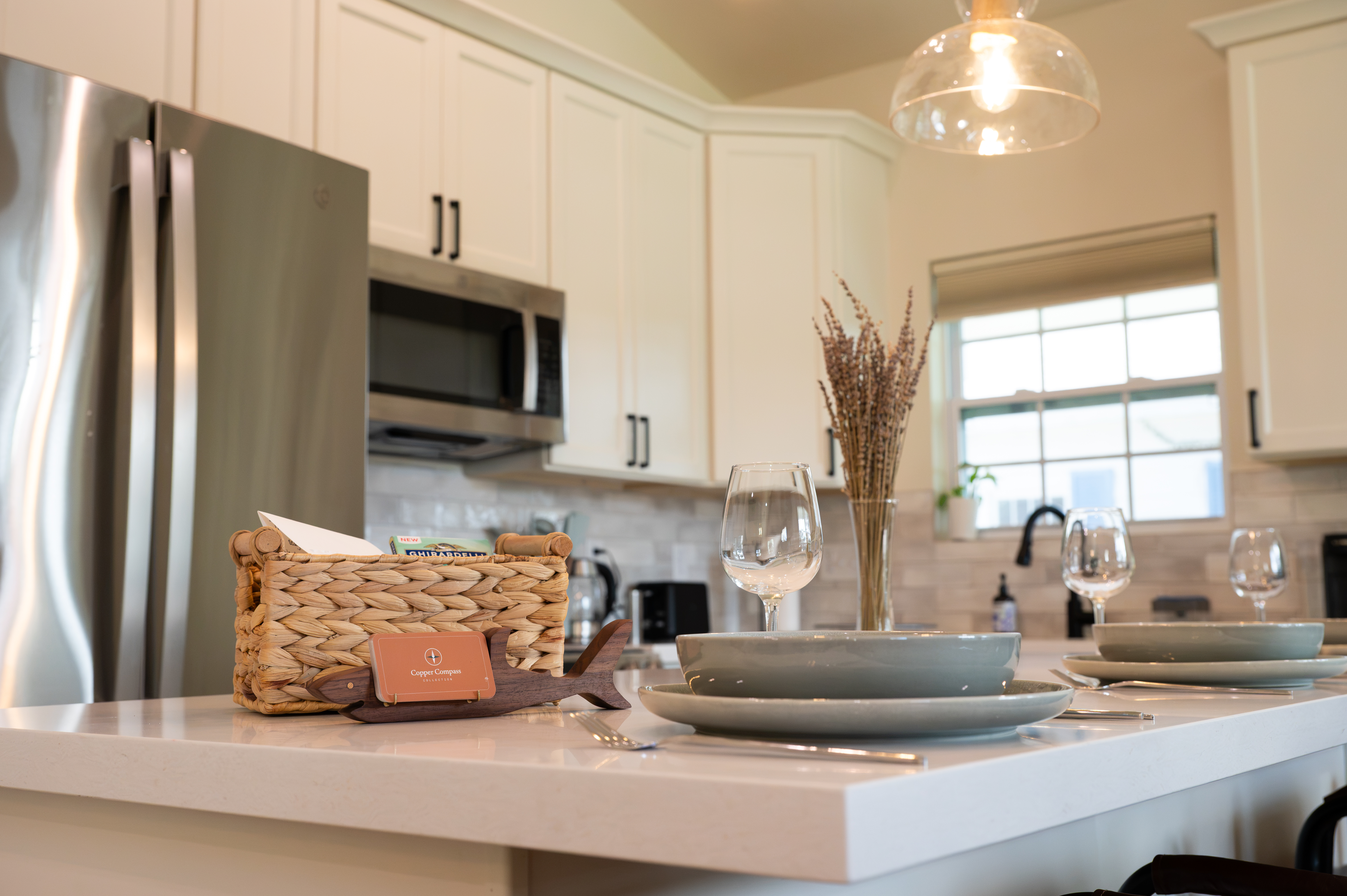 Bright modern kitchen with island dining and stainless steel appliances