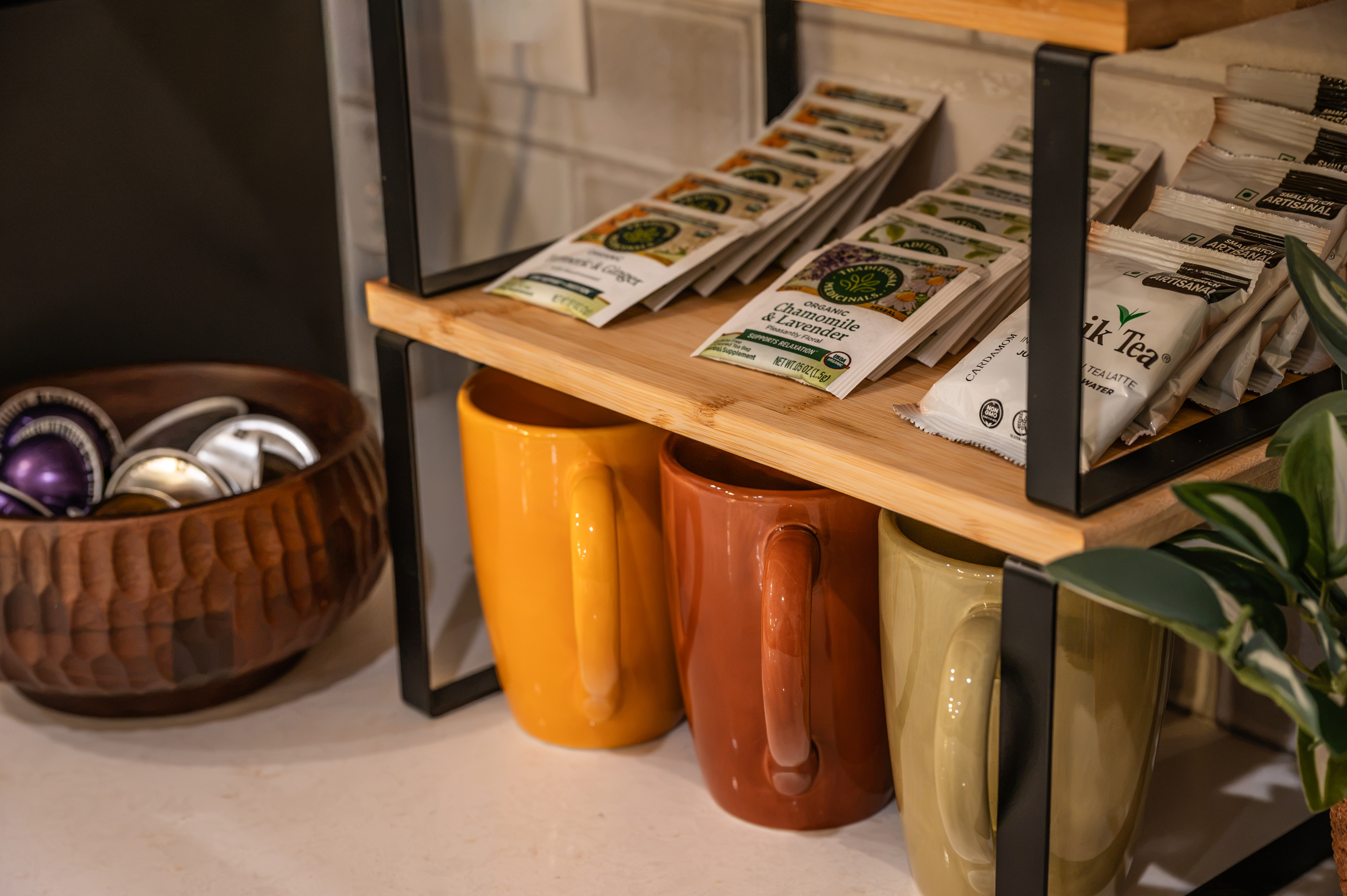 Inviting coffee & tea station with colorful mugs and guest-ready amenities