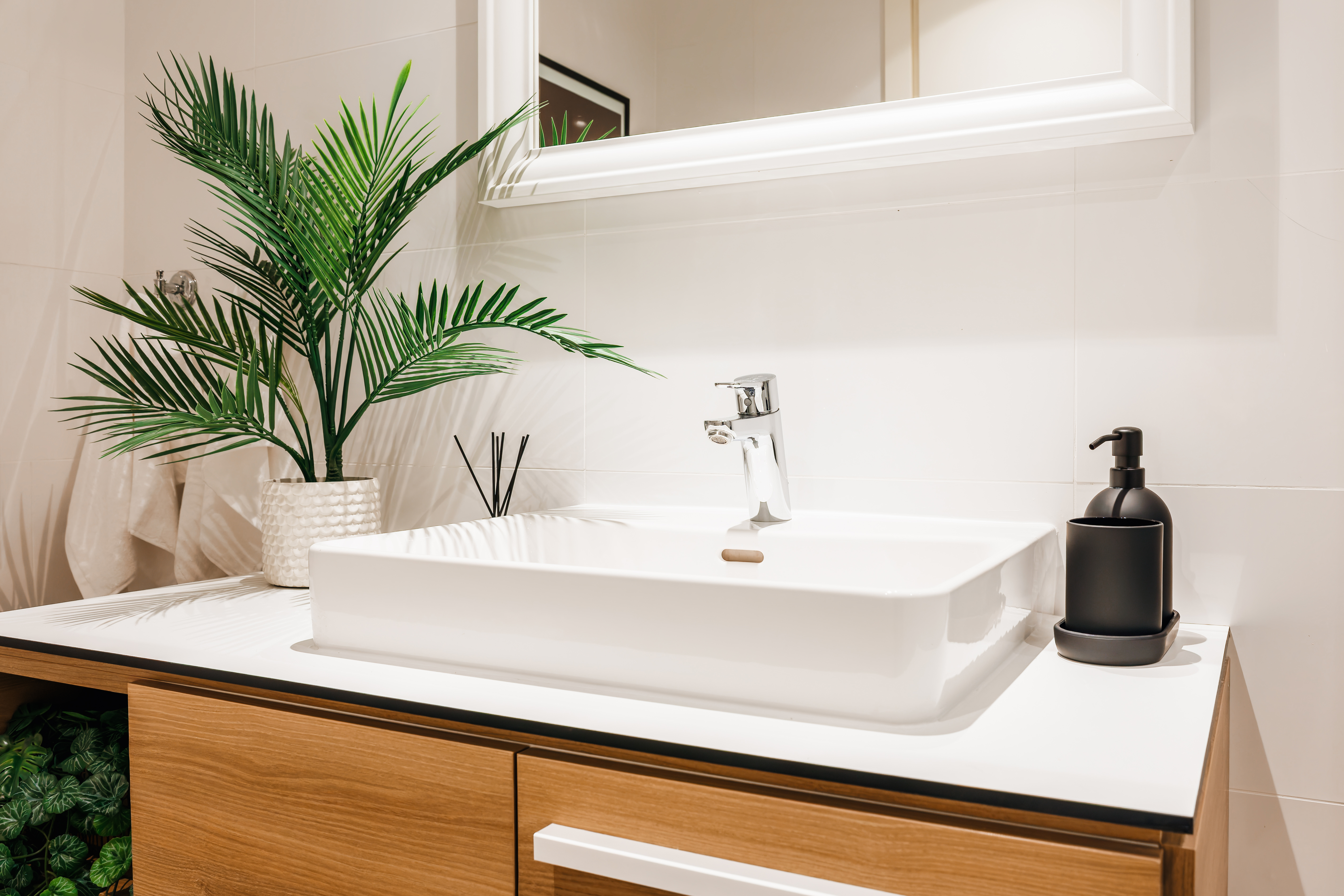 Bright modern bathroom vanity with spa-like styling and warm wood accents