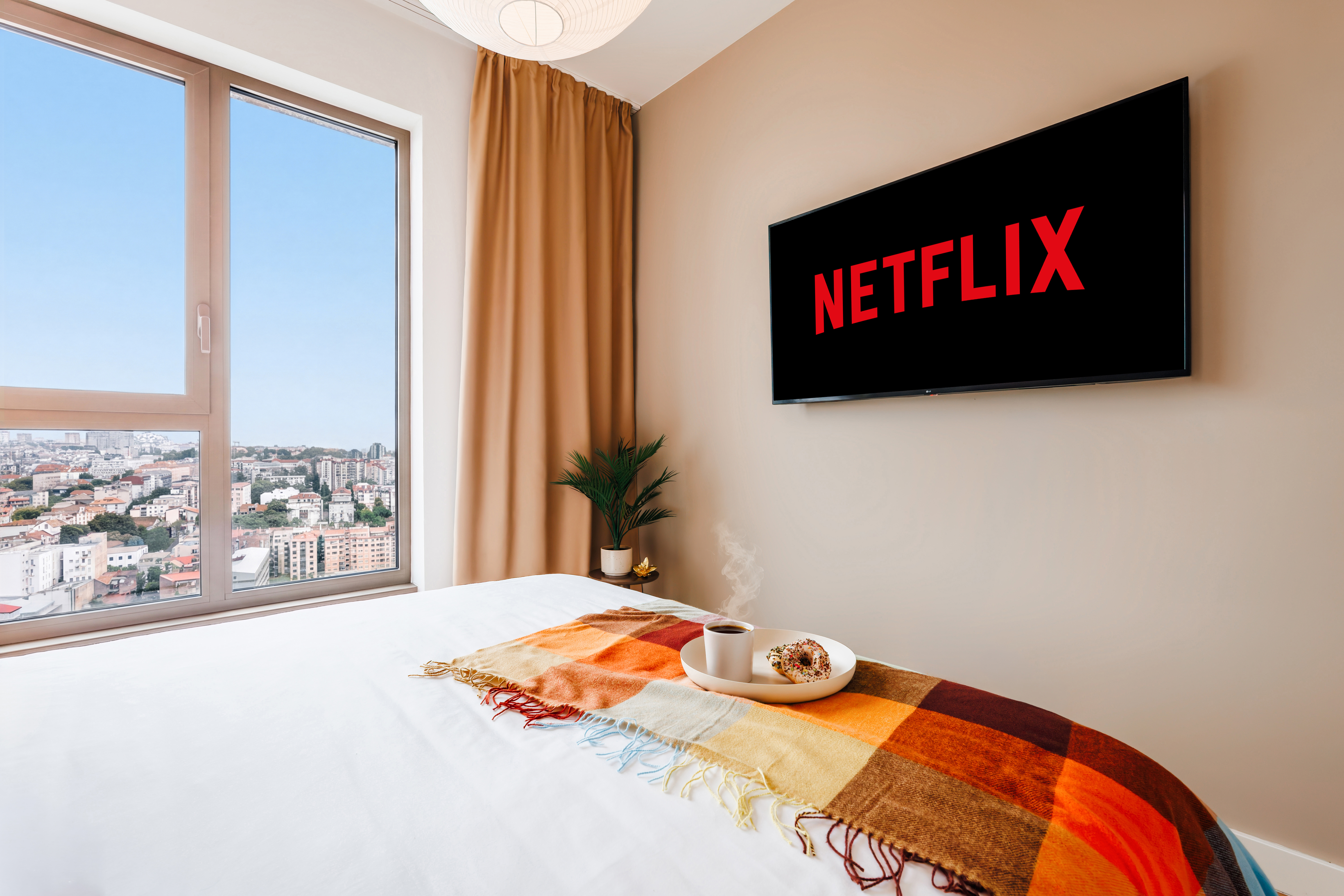 Wake up to skyline views and unwind with Netflix in this cozy modern bedroom