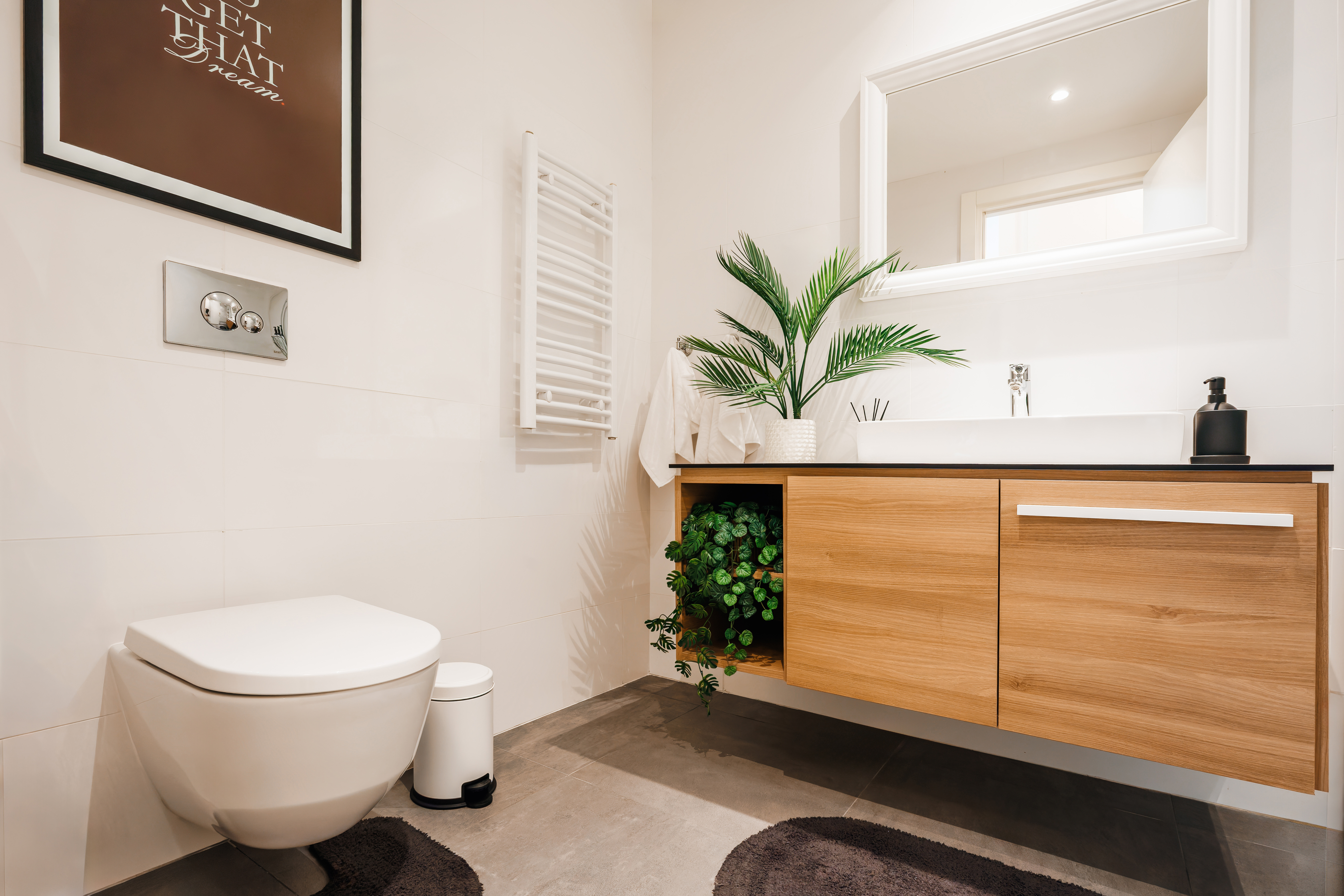 Bright modern bathroom with floating vanity, towel warmer, and sleek finishes