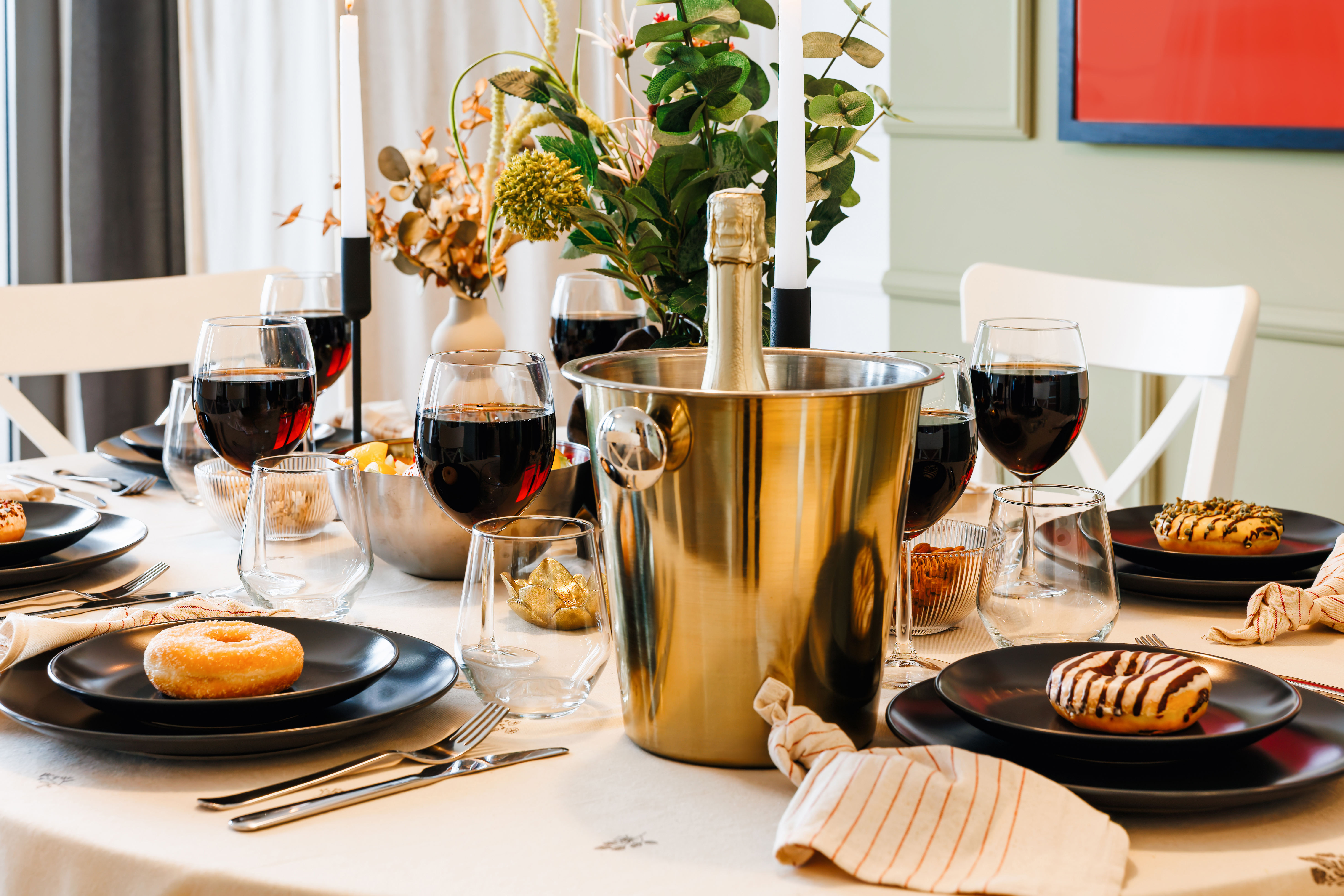Elegant dining setup with champagne, candlelight, and a festive feel