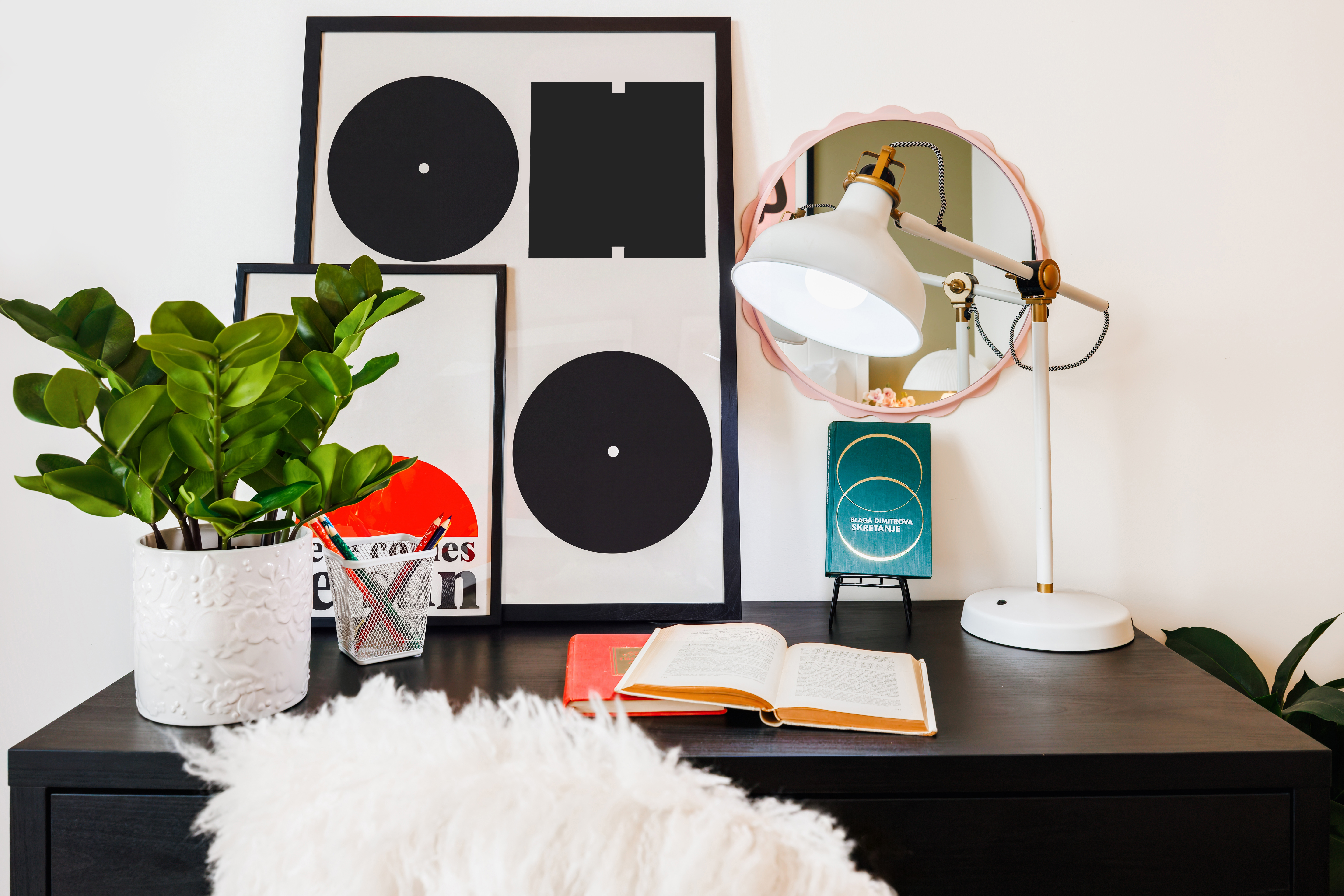 Stylish modern workspace with bold art, warm lighting, and fresh greenery