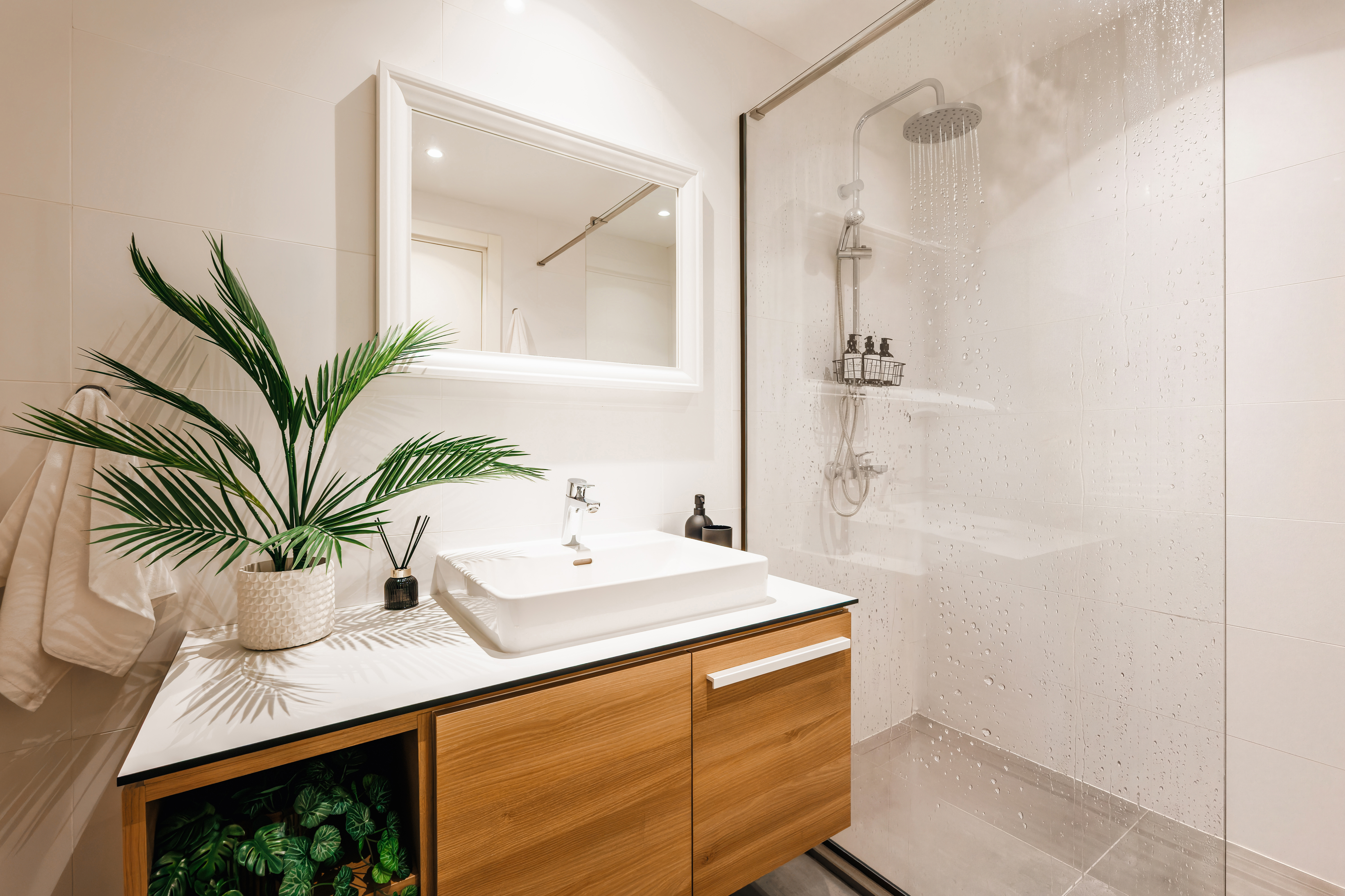 Bright spa-style bathroom with rainfall shower and modern vanity