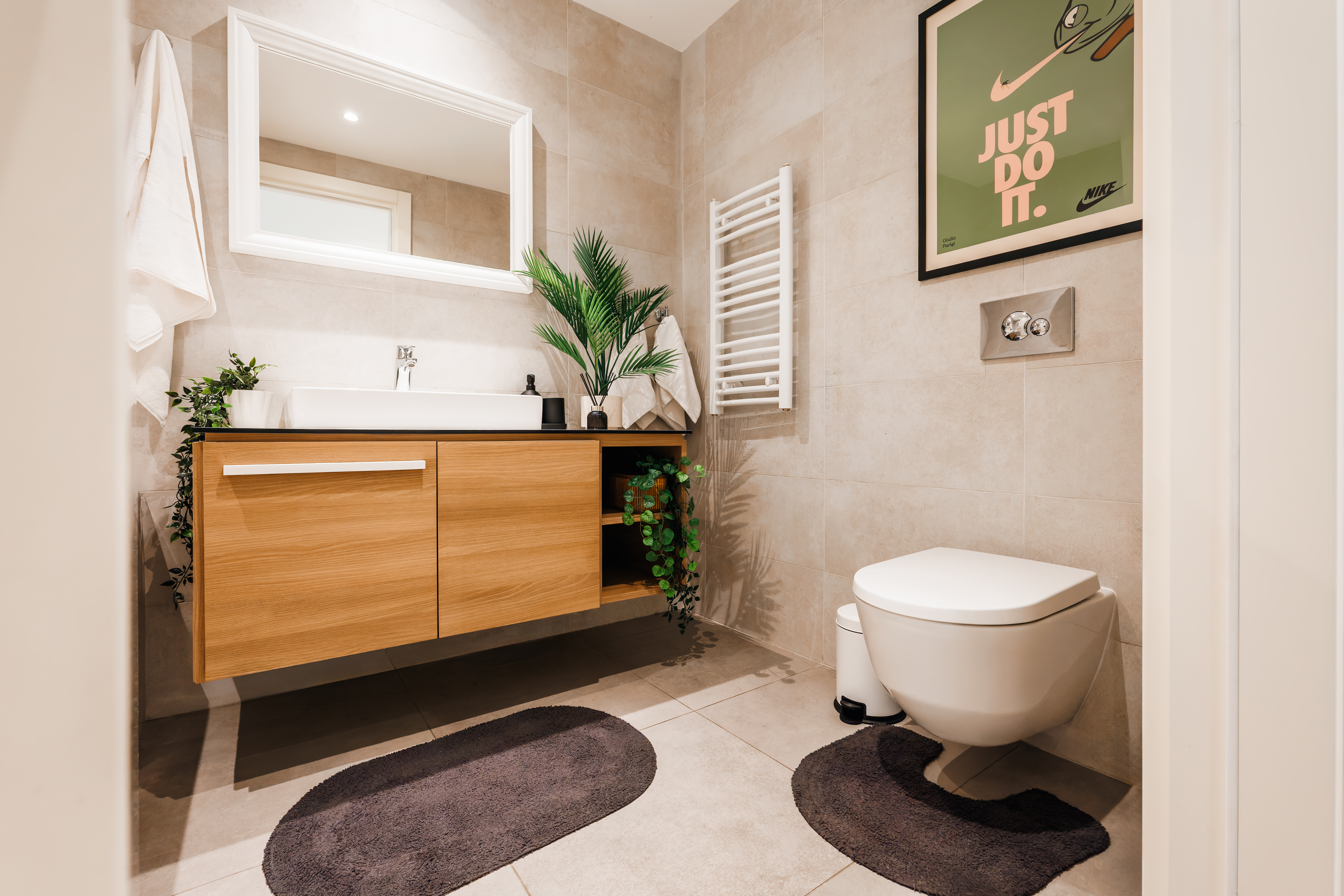 Modern spa-style bathroom with floating vanity and heated towel rail