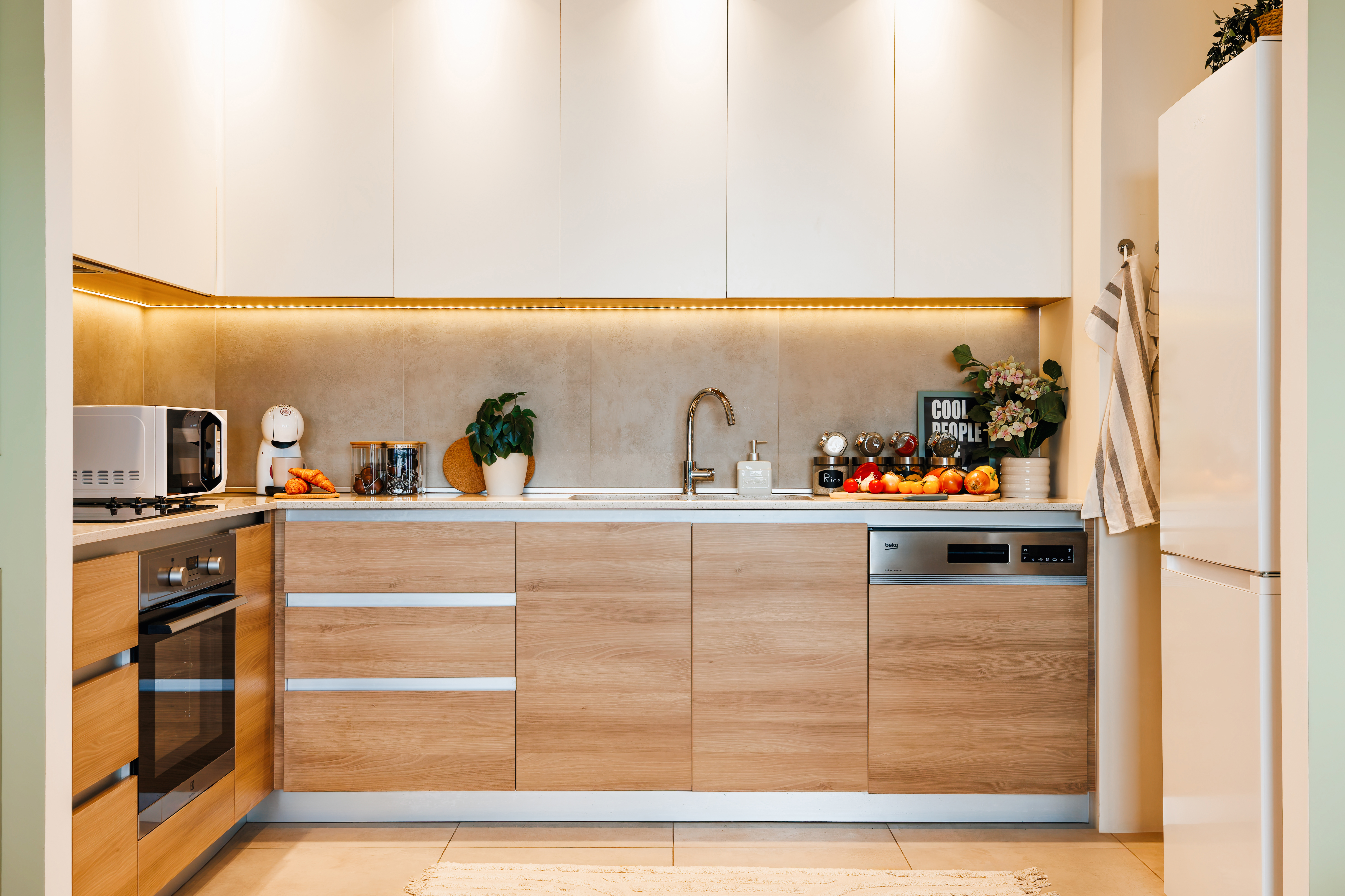 Bright modern kitchen with warm wood finishes and stylish ambient lighting