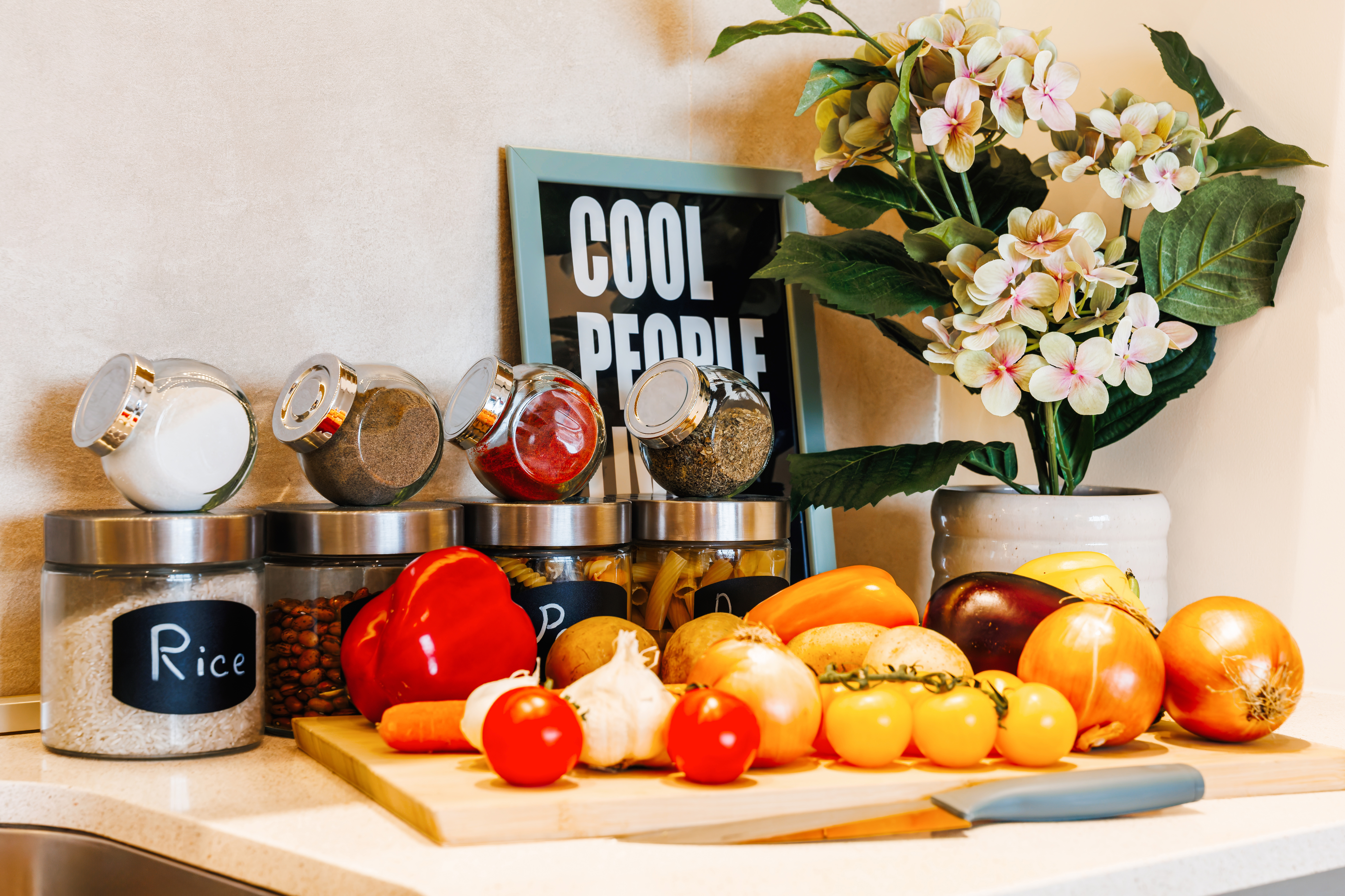 Fresh, stylish kitchen setup with organized pantry jars and prep space