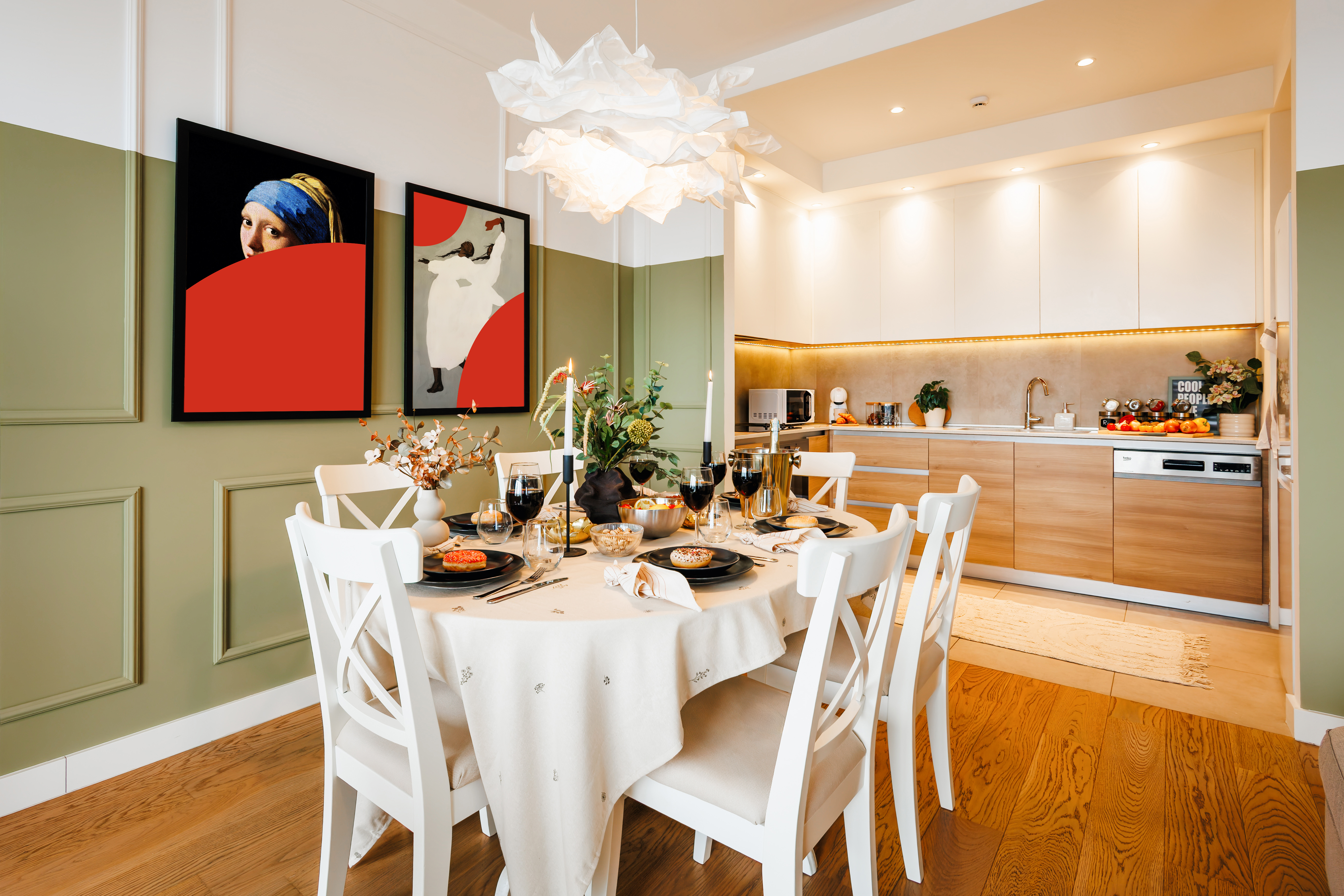 Elegant dining area with designer lighting and a sleek modern kitchen